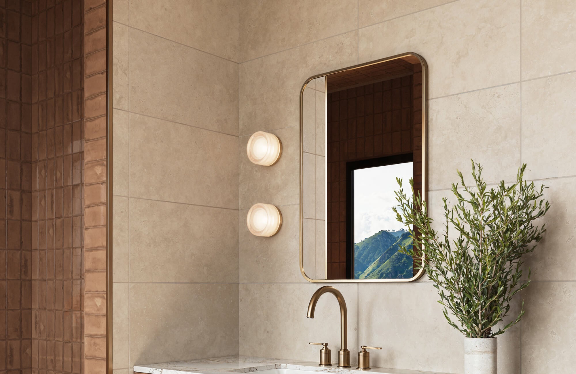 null Simple bathroom vanity with warm neutral wall tiles, brass faucet, and mirror in a minimalist modern design