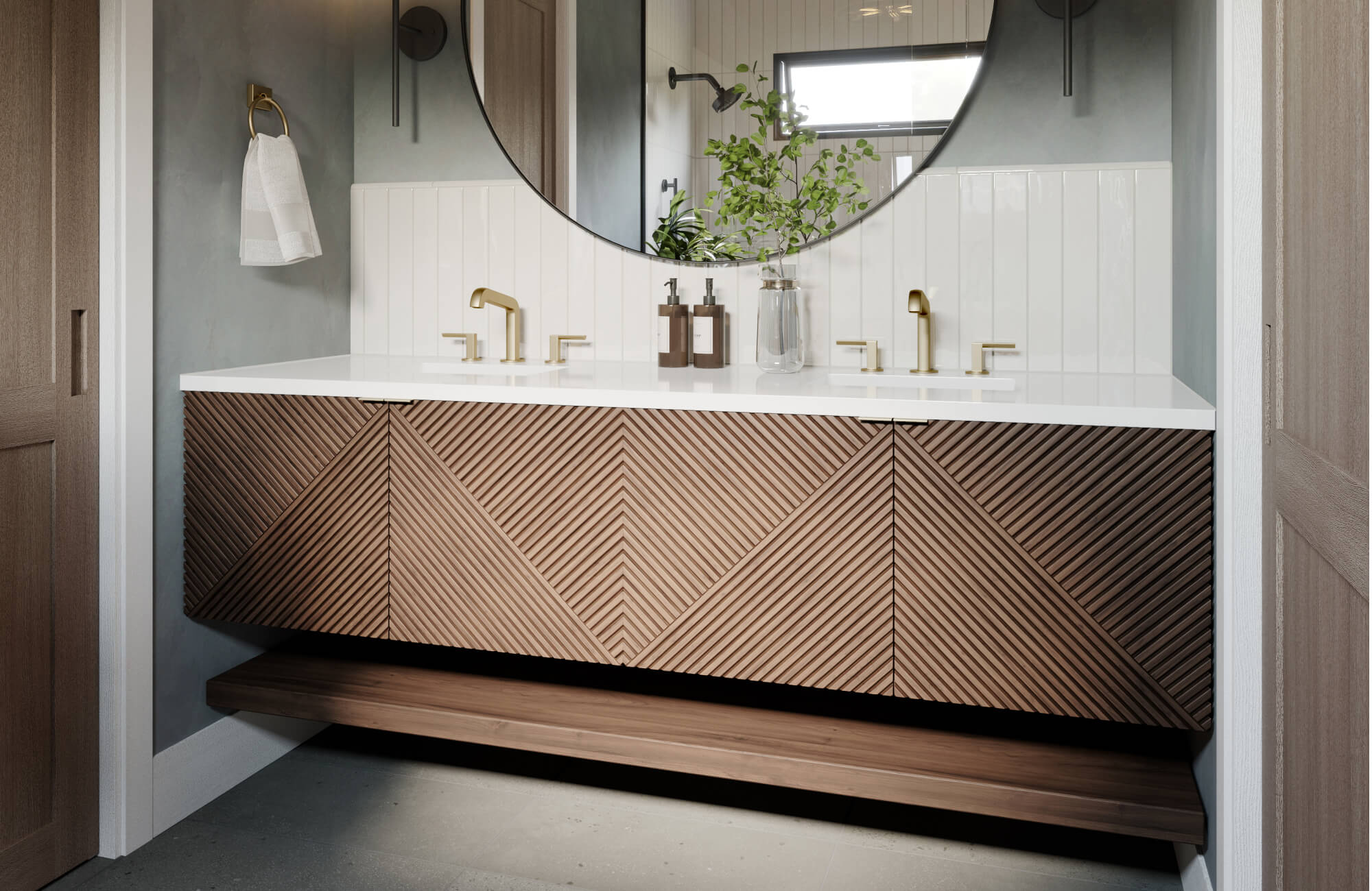 Textured wood vanity with chevron detailing, dual sinks, and brass fixtures set against glossy vertical white tile.