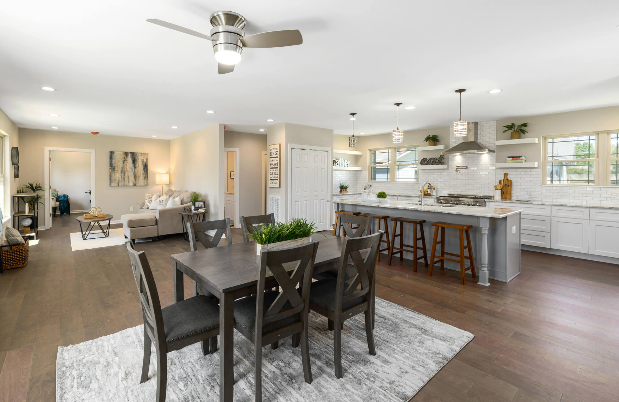 null Spacious modern kitchen with a central island, white cabinetry, stainless steel appliances, and pendant lighting for everyday dining.