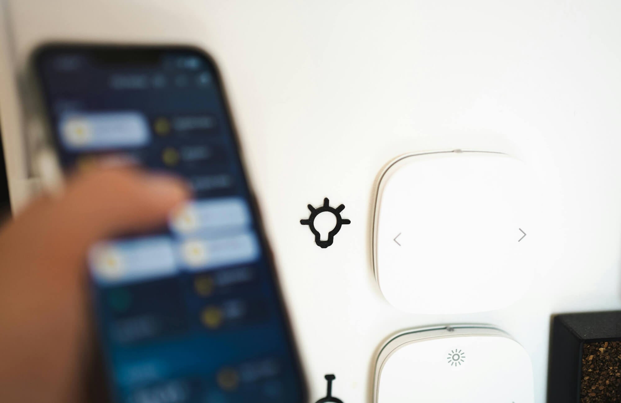 null Close-up of smart home controls operated by a smartphone, highlighting connected lighting and modern kitchen technology.