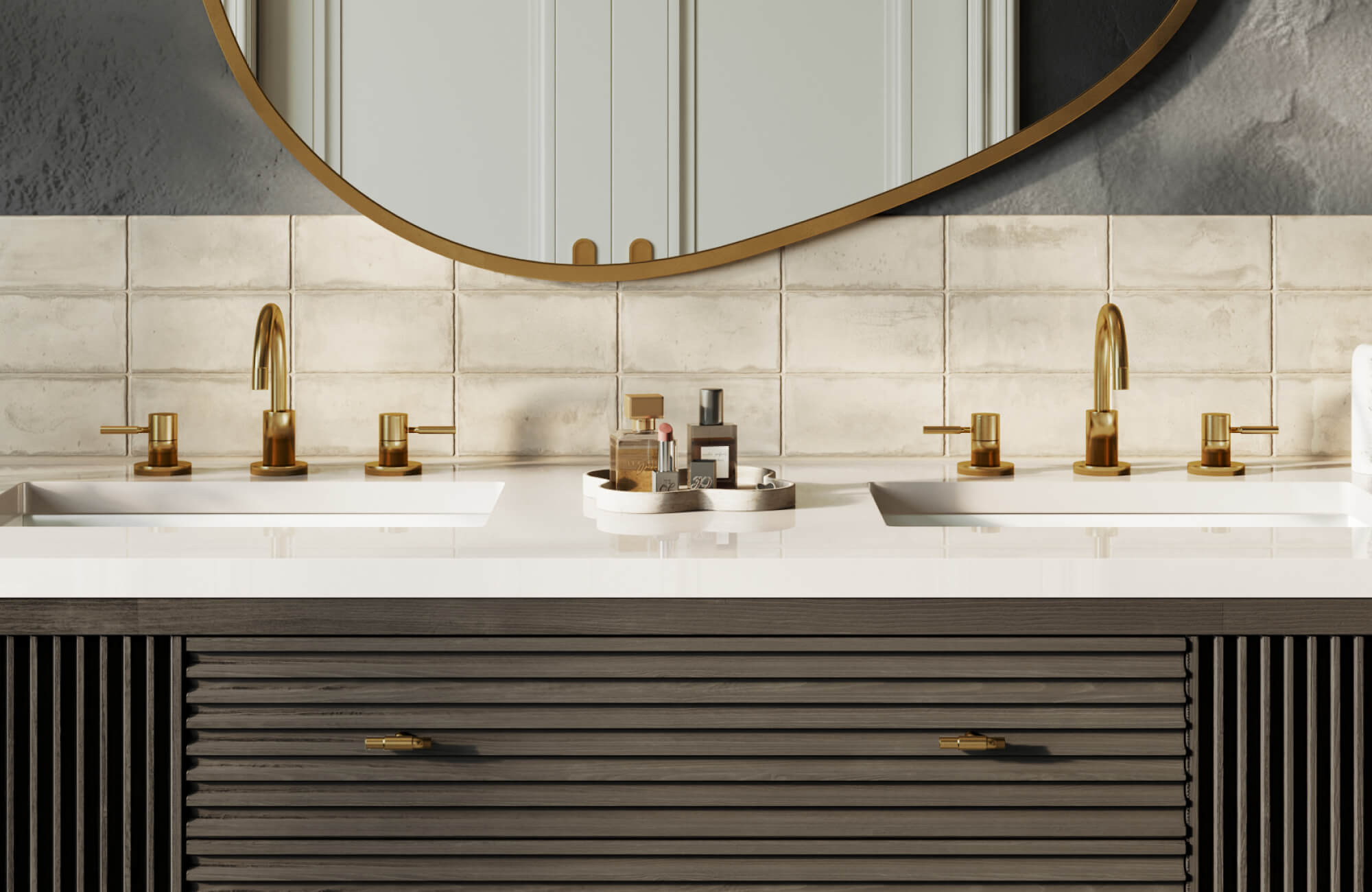 A double-sink vanity with a sleek white countertop, warm brass faucets, textured tile backsplash, and a curved mirror that brings balance and elegance to the bathroom design.