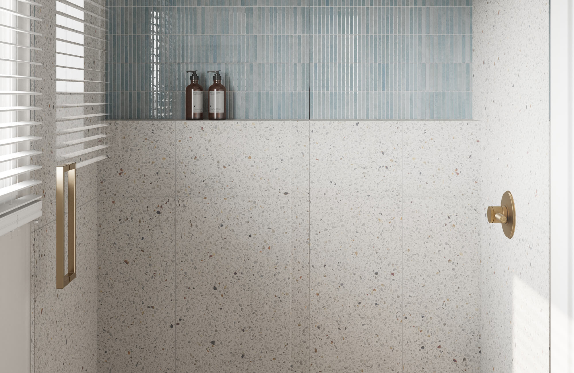 null Minimalist shower with speckled terrazzo tiles, soft blue subway tile accents, and sleek gold fixtures.