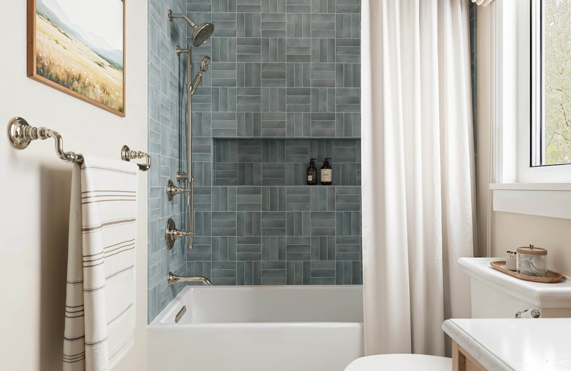 null Modern bathroom with matte blue patterned tiles in the shower, creating a sleek and calming aesthetic.
