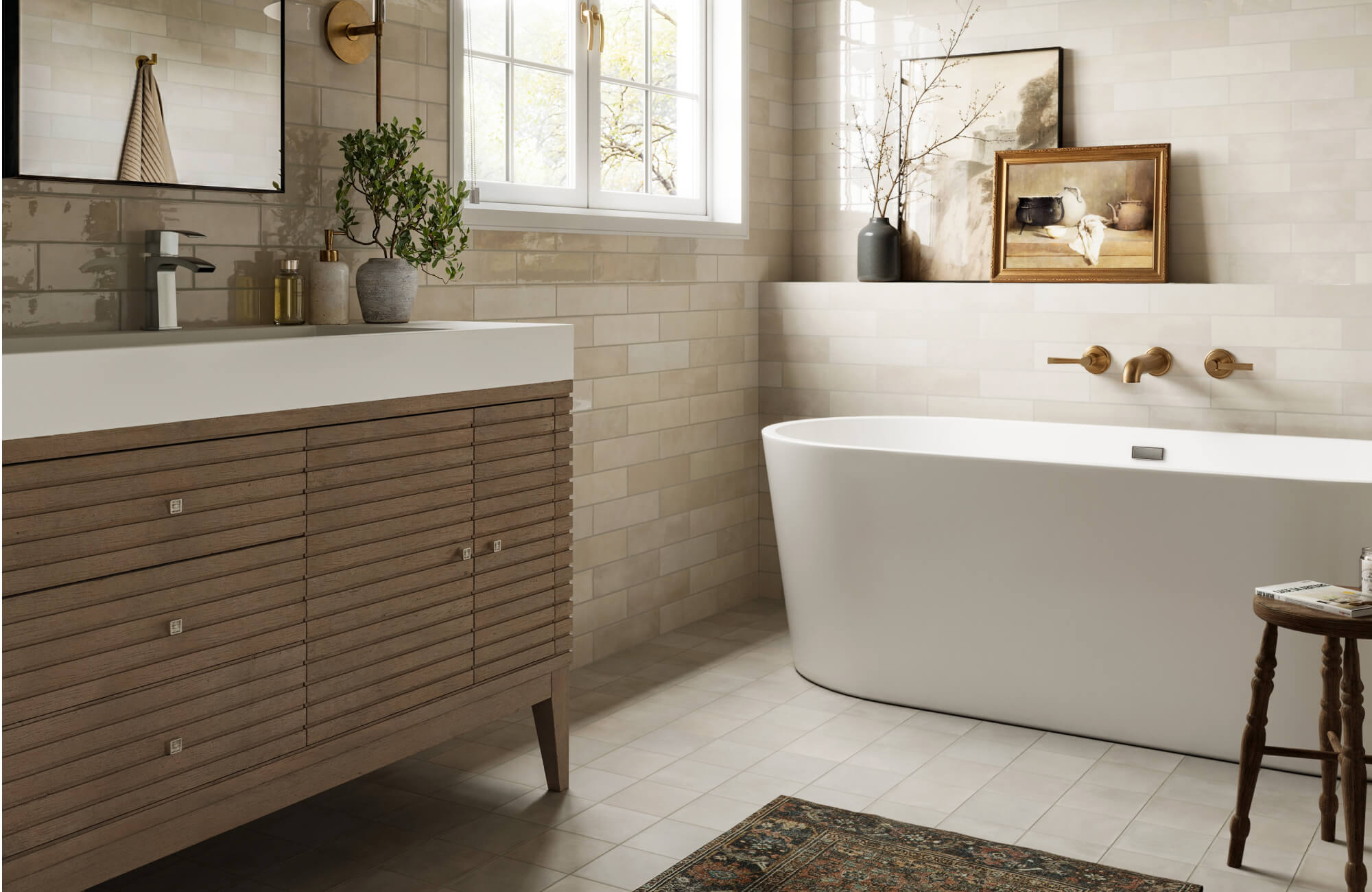 null Inviting bathroom renovation featuring a freestanding white soaking tub, warm wood vanity with integrated sink, soft neutral subway wall tiles, brass fixtures, and natural light that creates a calm, timeless atmosphere.