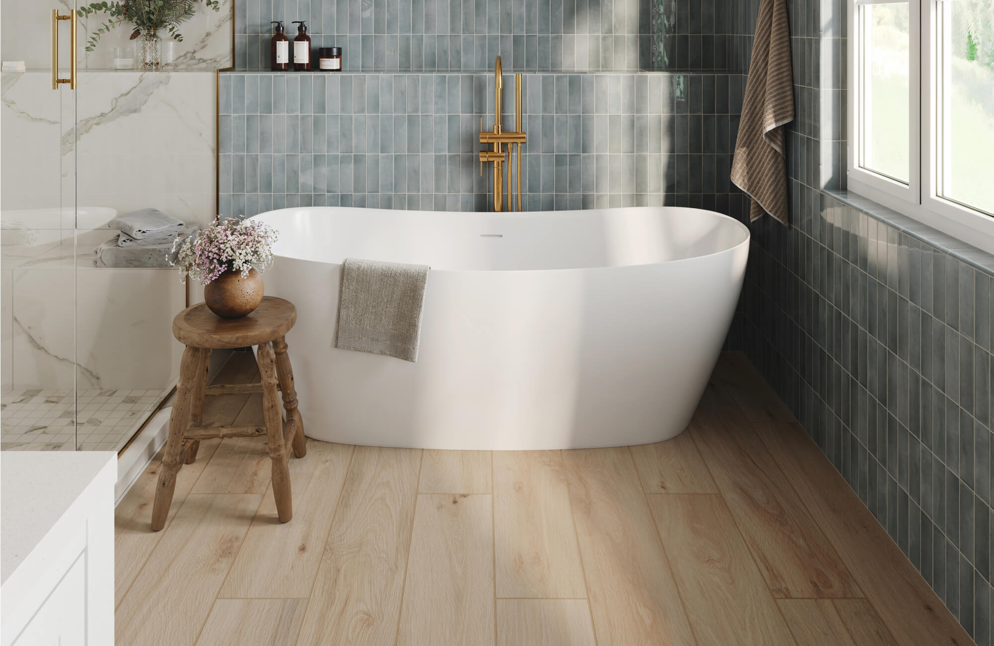 null Serene bathroom renovation featuring a sculptural freestanding soaking tub, soft blue vertical wall tiles, warm wood-look flooring, brushed brass fixtures, and natural light that enhances the calm, spa-inspired atmosphere.