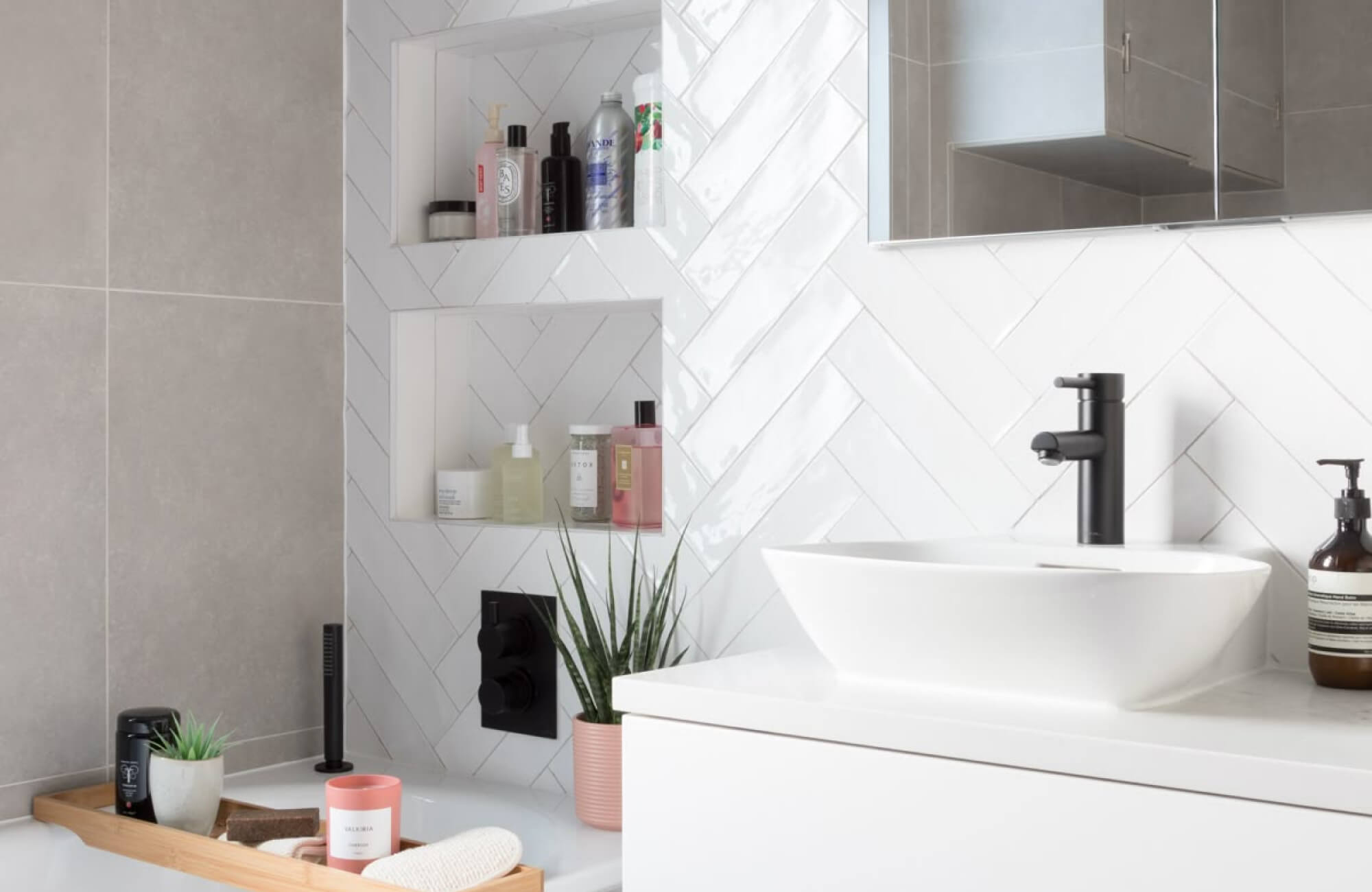 null Bathroom vanity with diagonal white subway tile backsplash and recessed wall shelves.