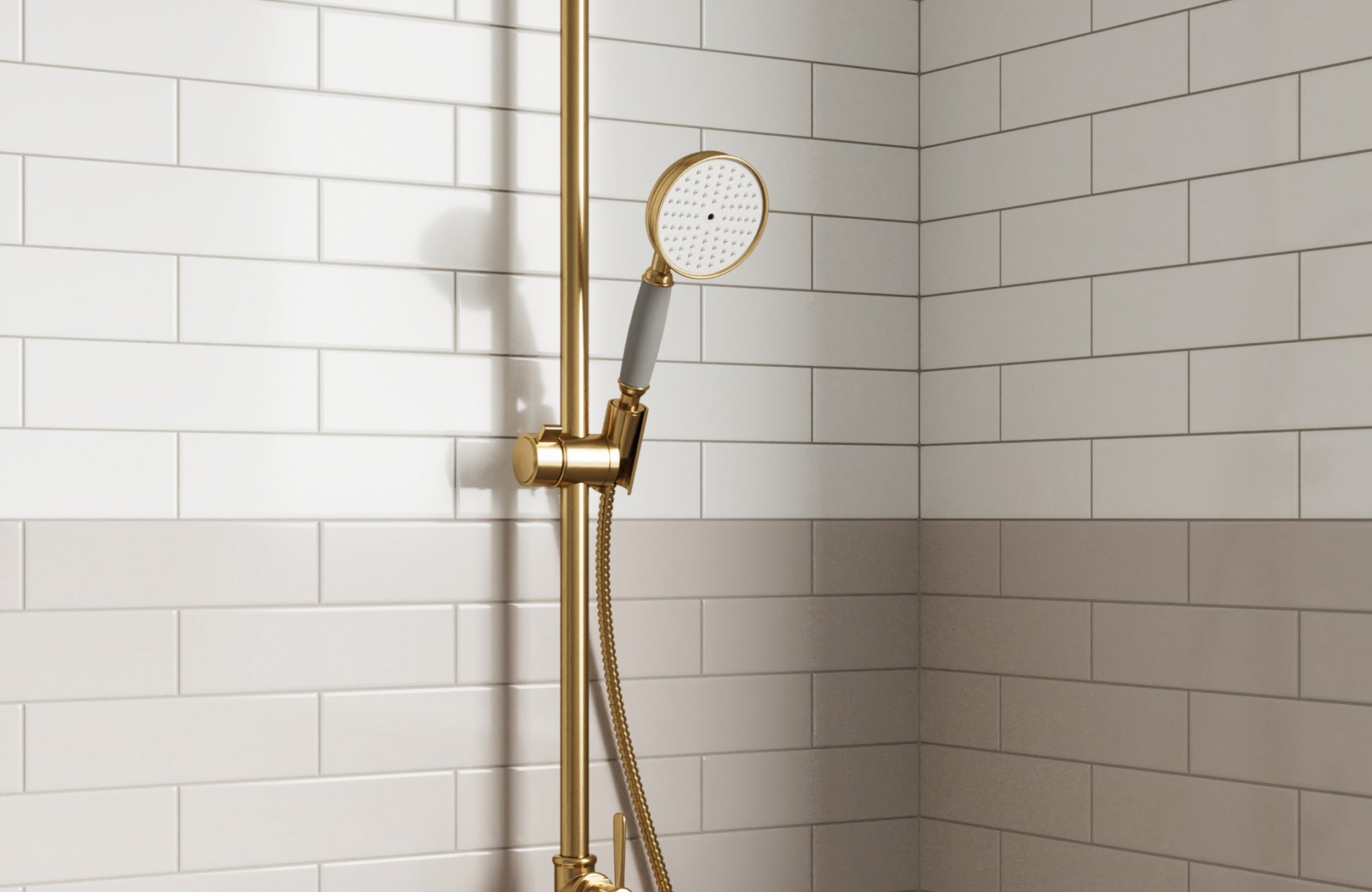 null White subway tile shower with two-tone design, paired with gold shower fixtures for a clean, elegant look.