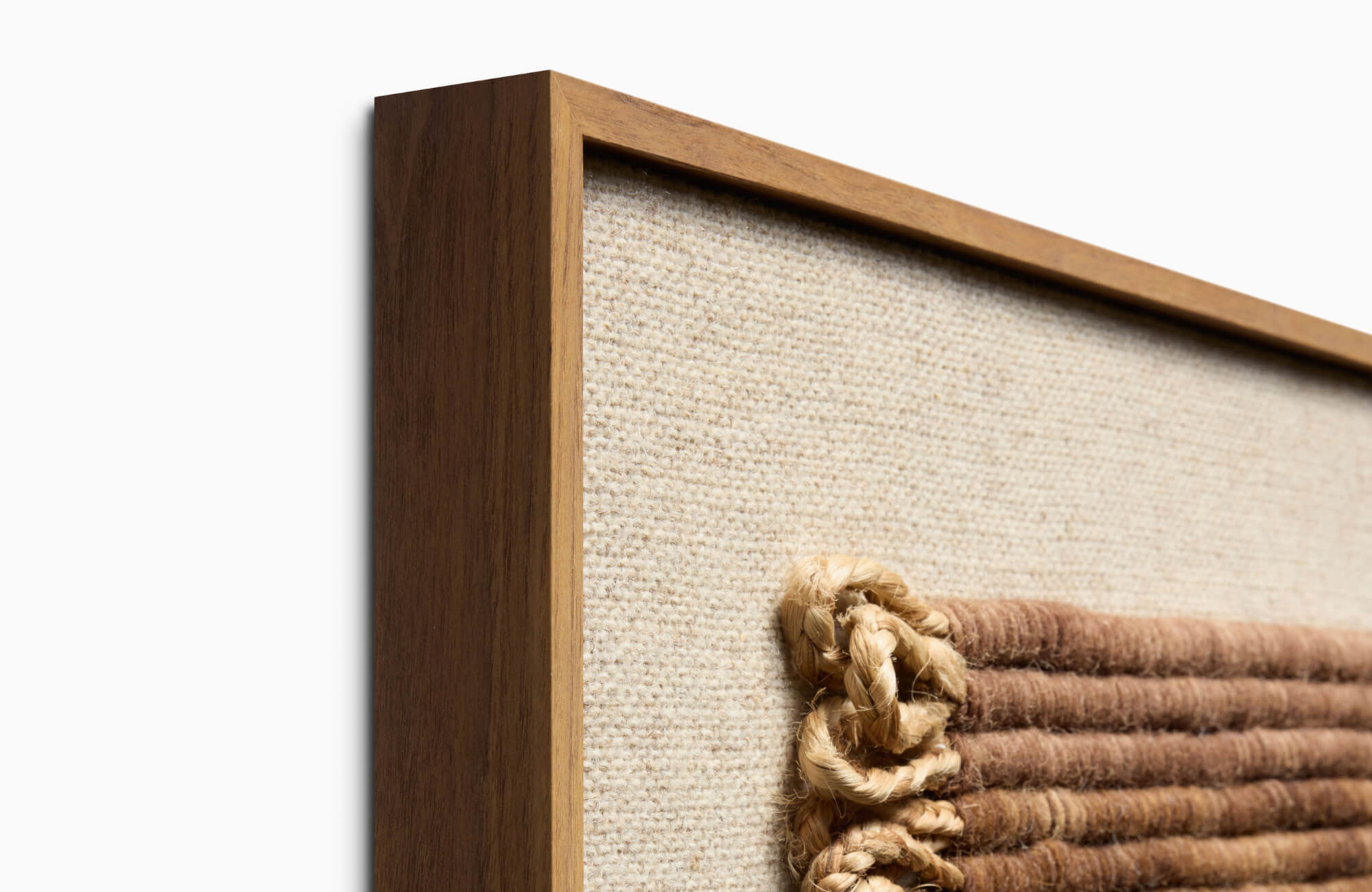 null Close-up of wooden frame with woven textile art, highlighting natural materials and refined craftsmanship.