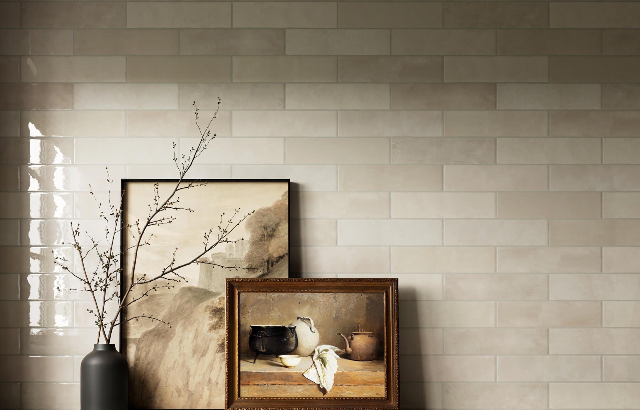 null Soft beige subway tiles in a running bond layout form a calm, neutral backdrop with minimal artwork and natural accents.