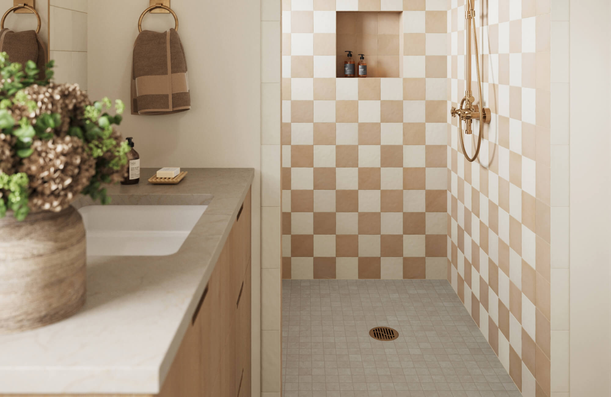 Walk-in shower with beige and white checkerboard shower wall tile installation and small light gray mosaic shower floor tiles with built-in niche.