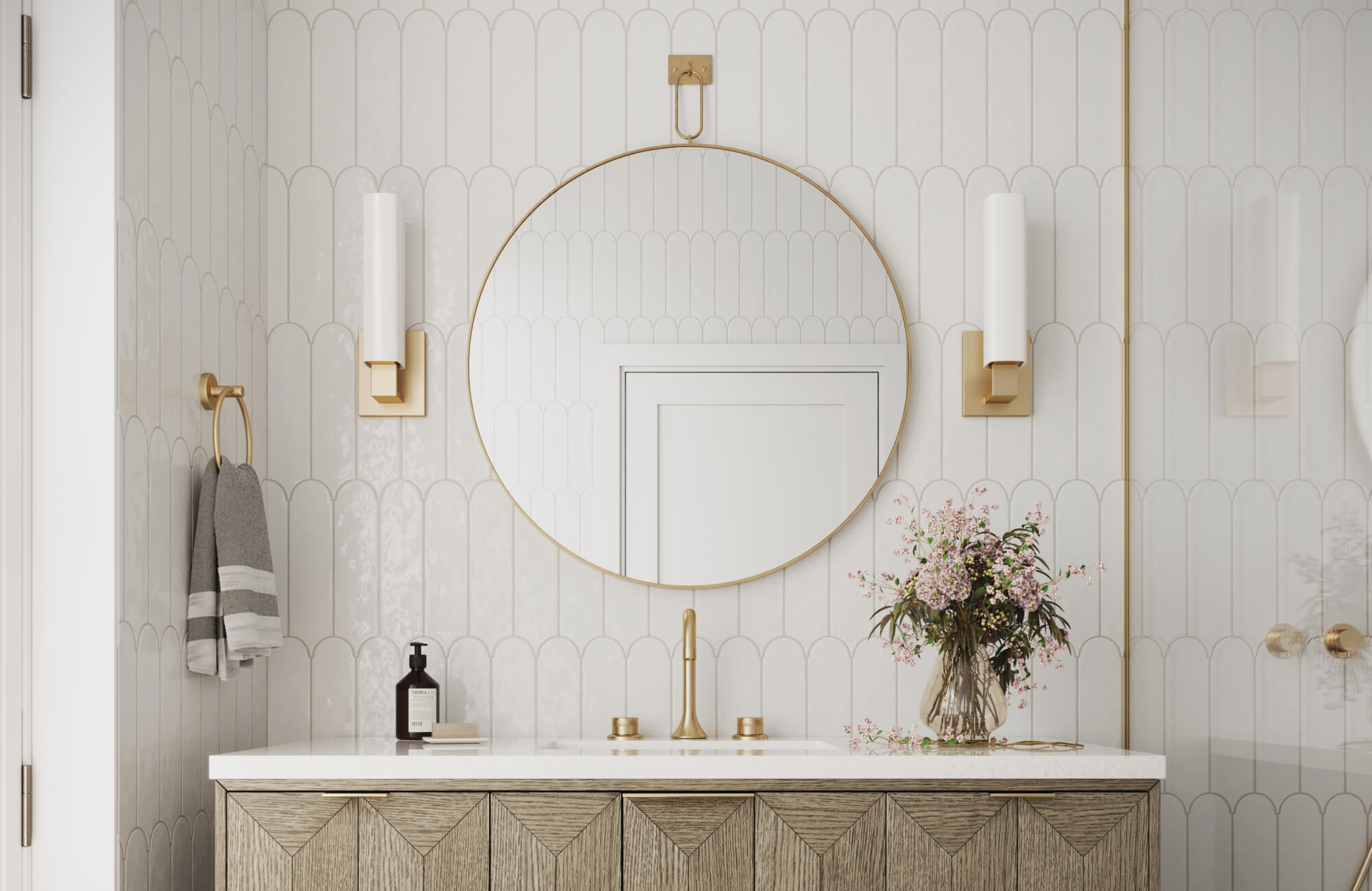 Round brass-framed mirror over vanity in light-filled bathroom, perfect for elegant and functional mirror placement in small spaces.