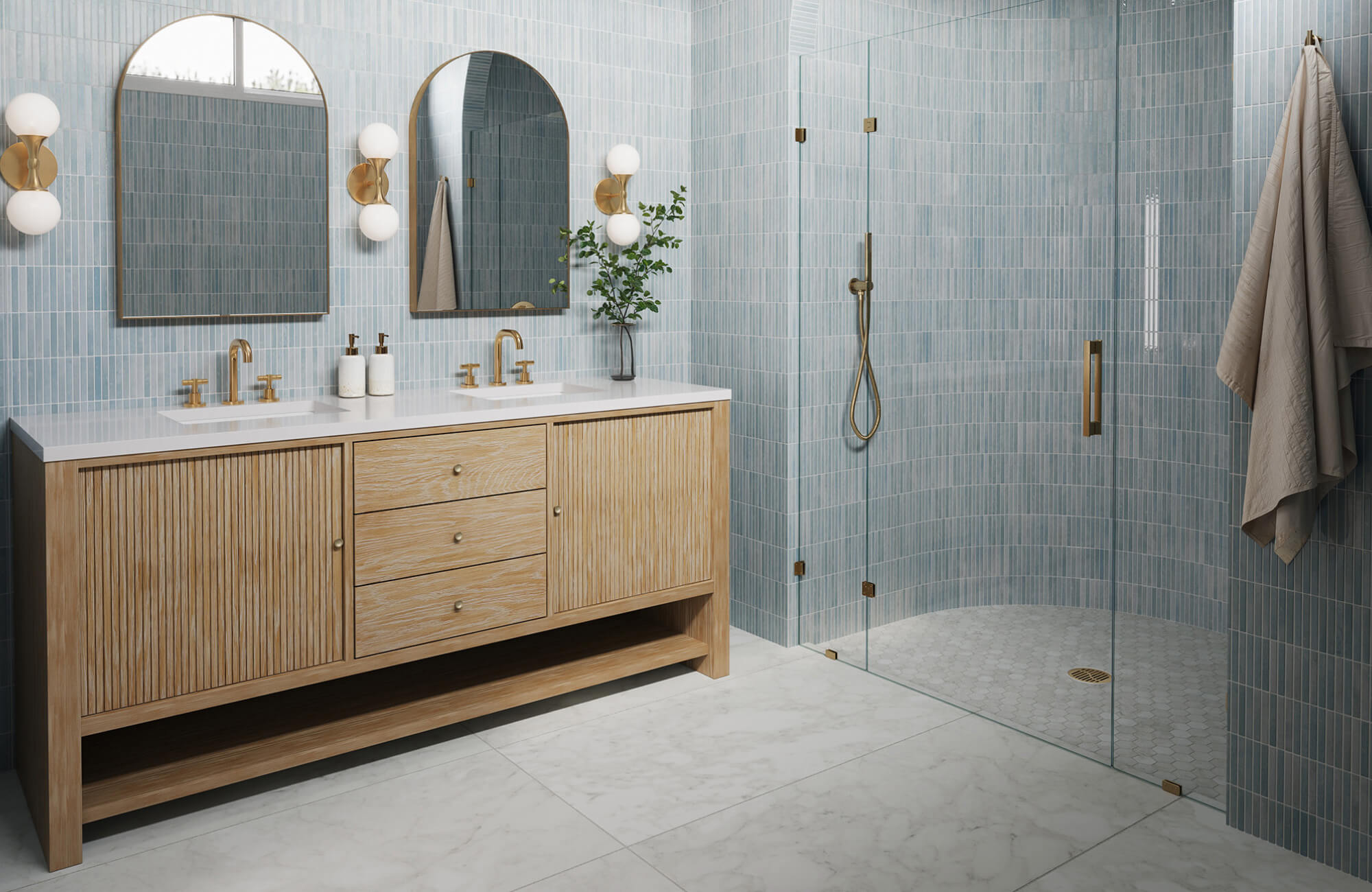null Contemporary bathroom with a light wood double-sink vanity, arched mirrors, brass fixtures, and a glass-enclosed shower with blue tile walls.