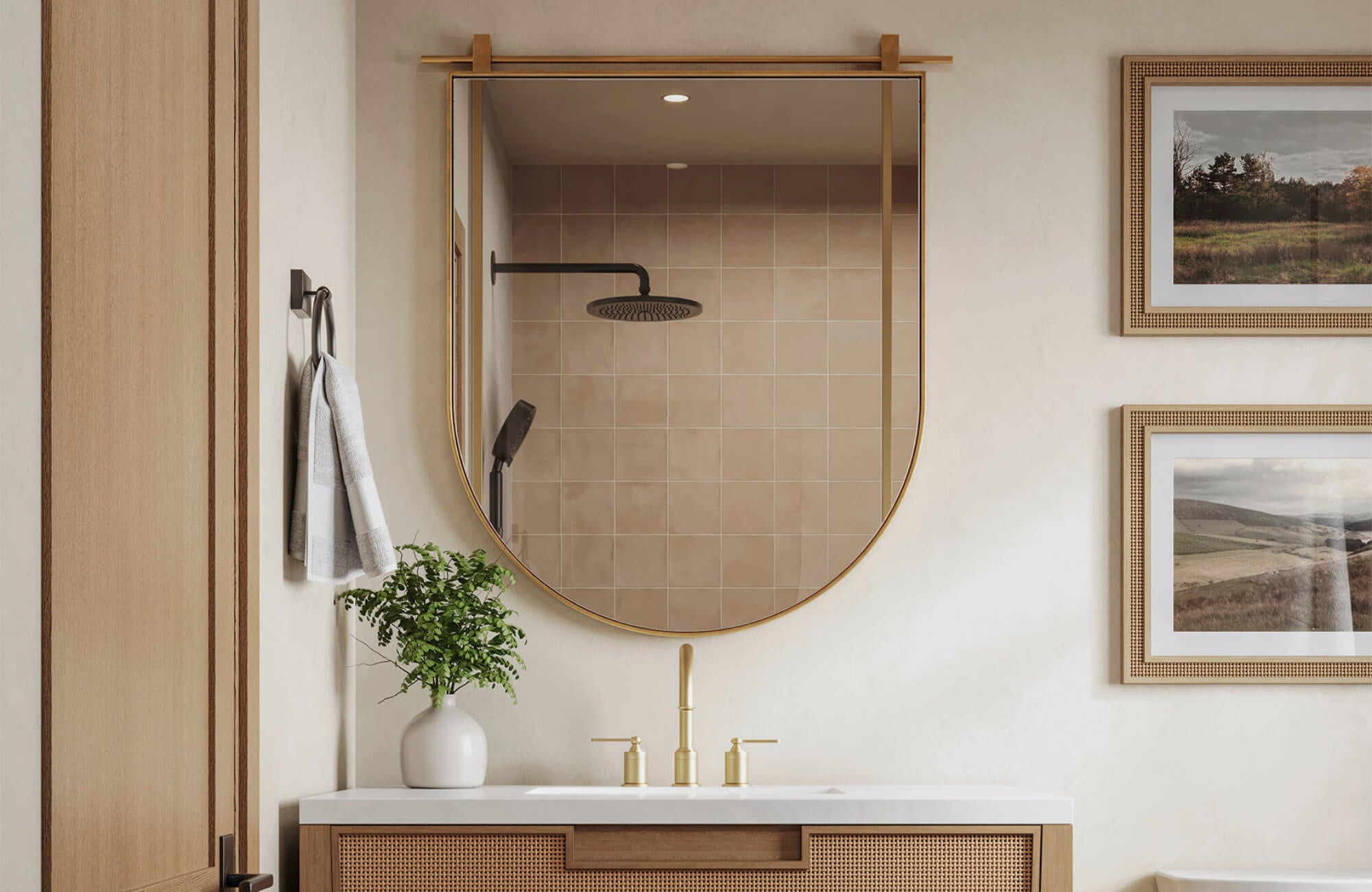 null Warm-toned bathroom with a gold-framed arched mirror, woven vanity, brass fixtures, and soft tile backsplash for a cozy, modern look.