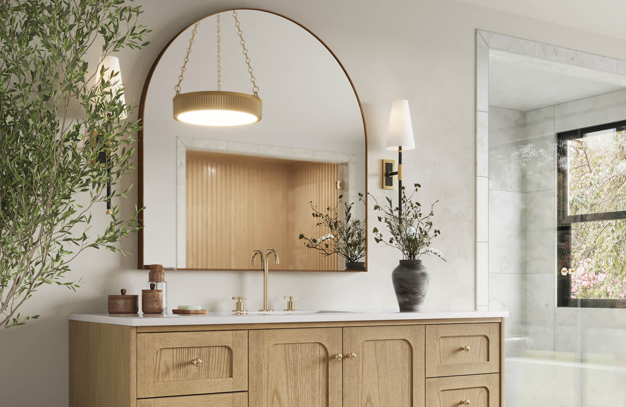 null Bathroom with a large gold-framed arched mirror, light wood vanity, brass fixtures, and soft lighting for a warm, sophisticated look.