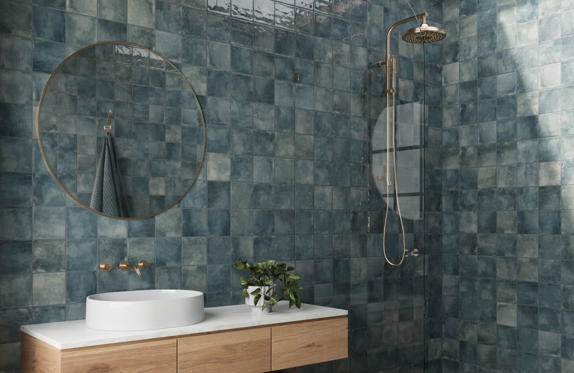 Contemporary bathroom with glossy blue square ceramic tiles, gold fixtures, a round mirror, and a floating wood vanity with vessel sink.