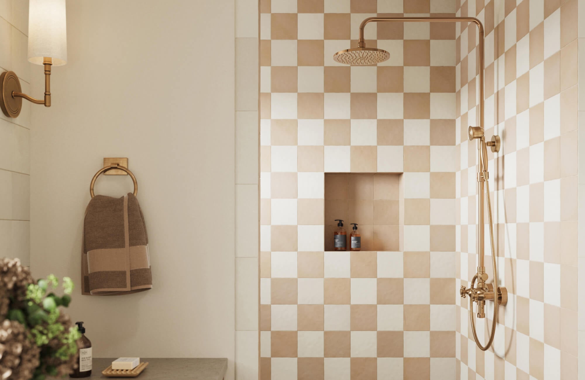 Warm beige and cream checkerboard tiles bring cozy elegance to a modern shower with brass fixtures and built-in niche.