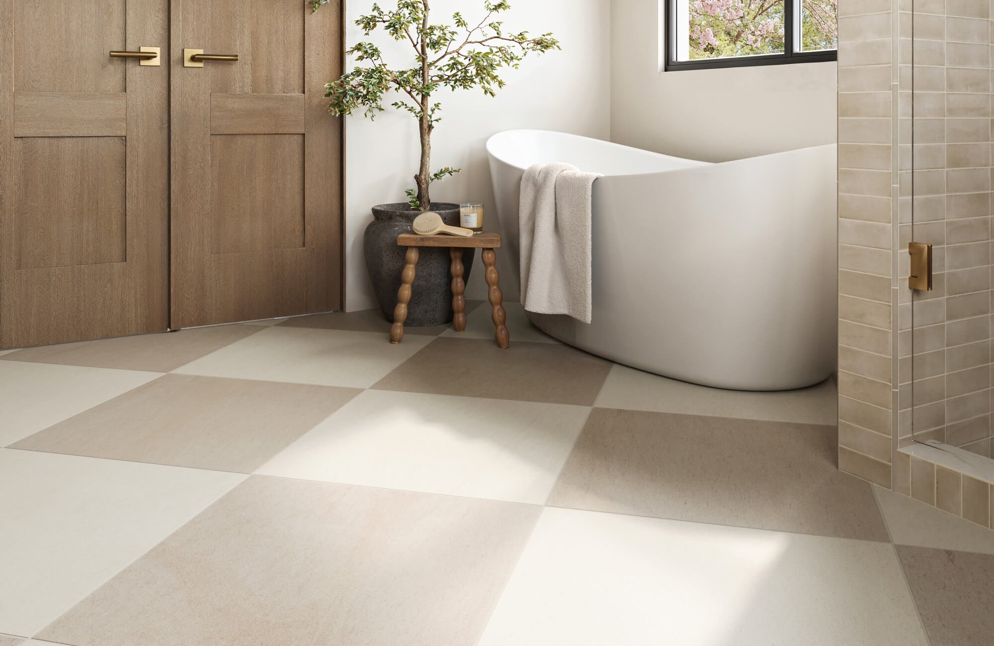Soft beige and ivory checkerboard tiles anchor a spa-like bathroom with a sculptural tub and natural wood accents.