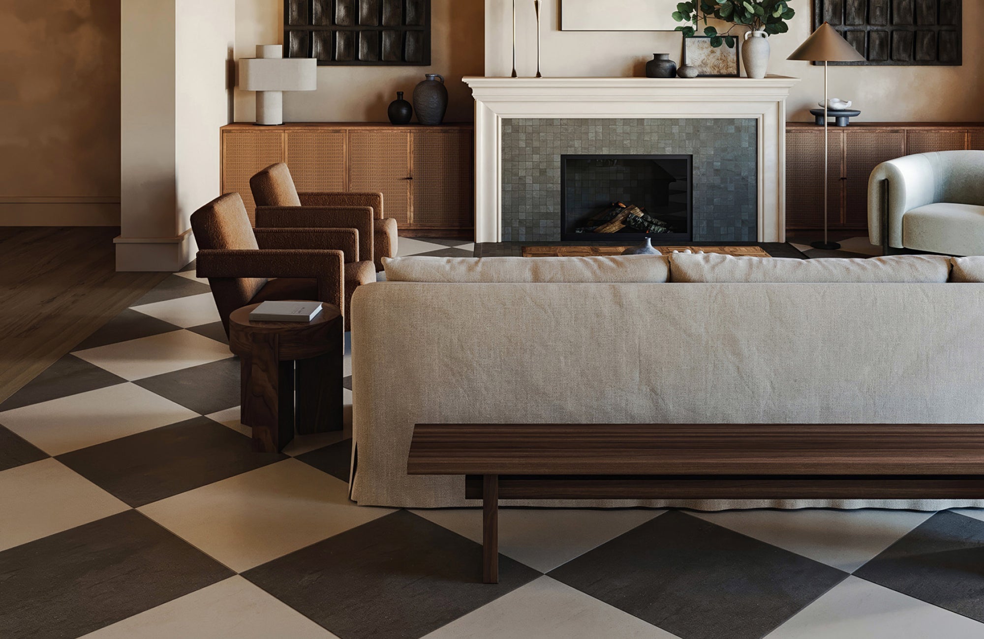 Sophisticated living room with bold charcoal and ivory checkerboard tiles beneath warm-toned furnishings.