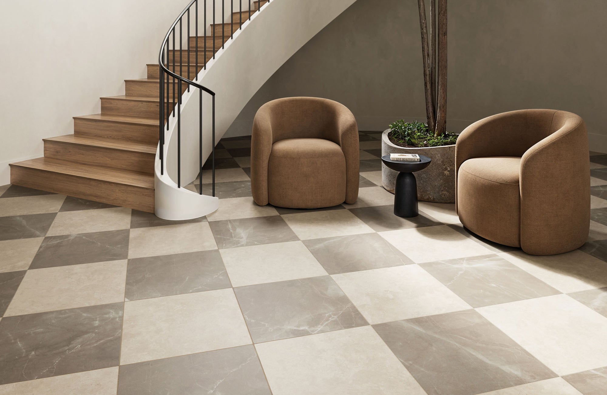 Contemporary space with oversized checkerboard porcelain tile flooring in taupe and beige tones under a curved stairway.
