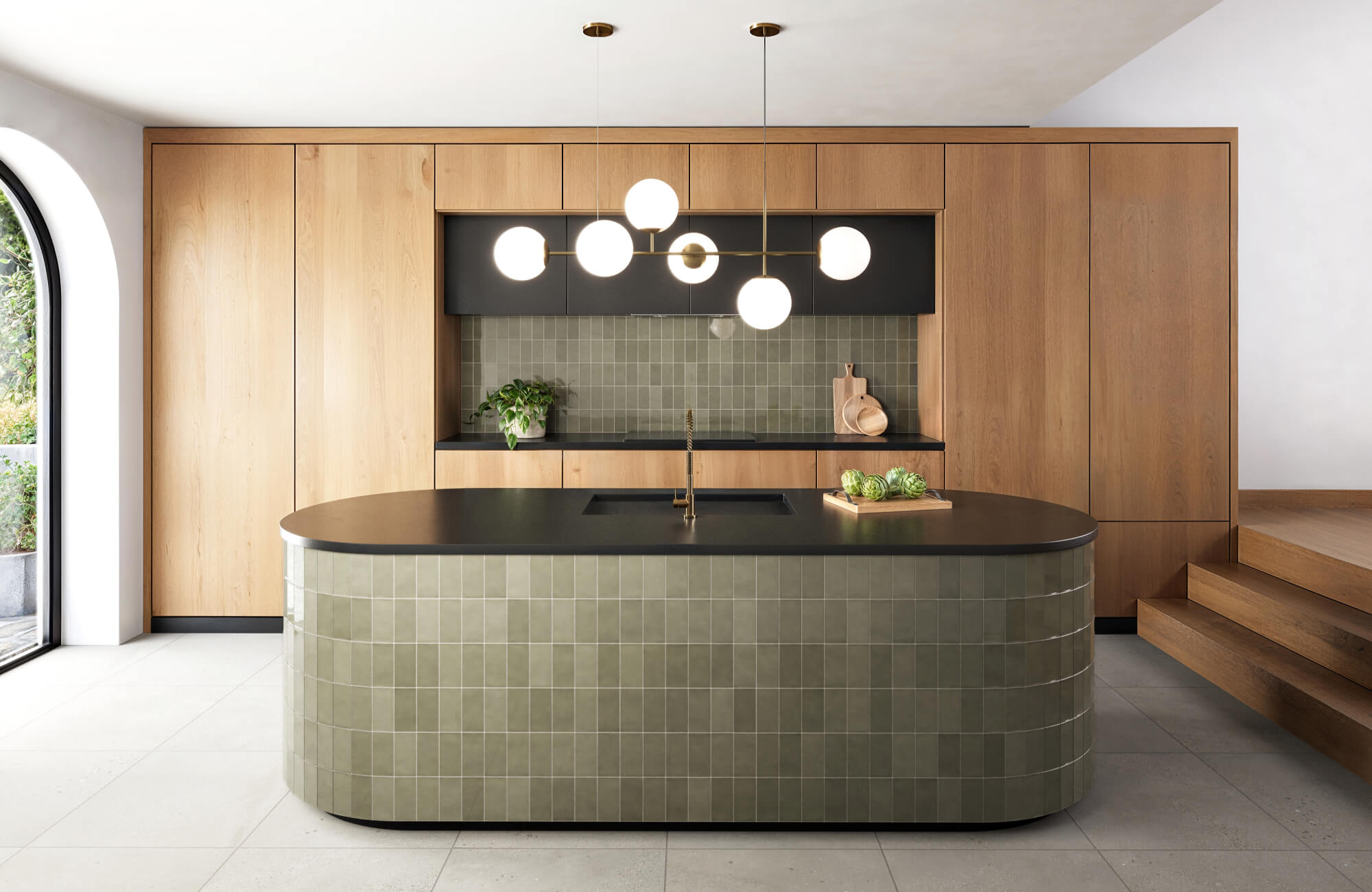 null Olive-toned vertical tiles wrap a curved island and backsplash, blending with wood cabinetry and black accents for a sleek, earth-inspired kitchen design.