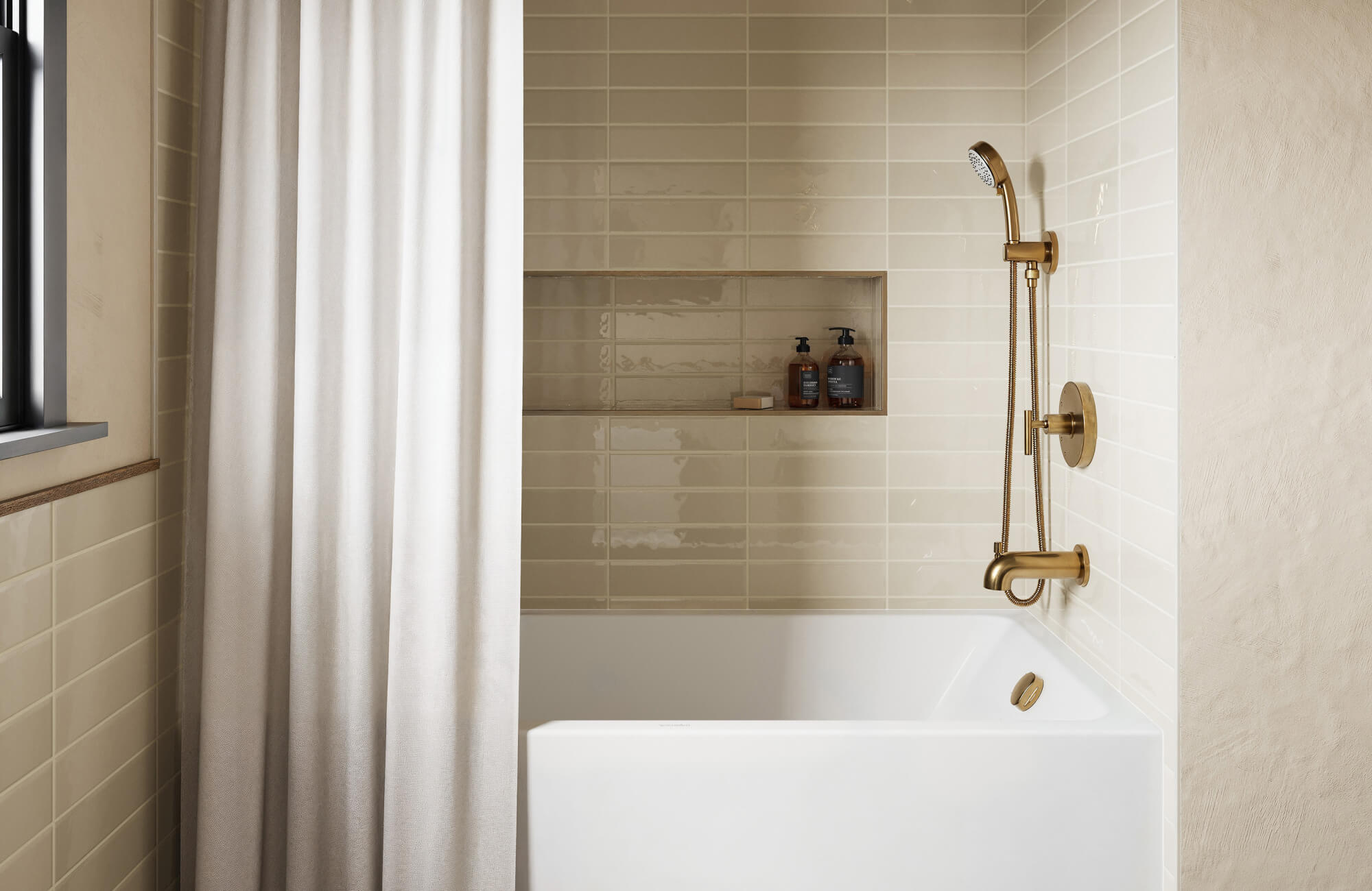null A soft neutral tile backdrop and warm gold shower hardware create a calming, modern look in this small bathtub corner.
