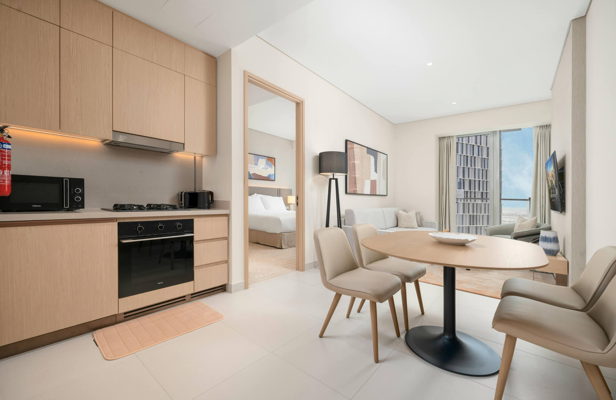 Modern open-plan kitchen with a soft beige runner rug adding subtle style and cushioning to the cooking area.