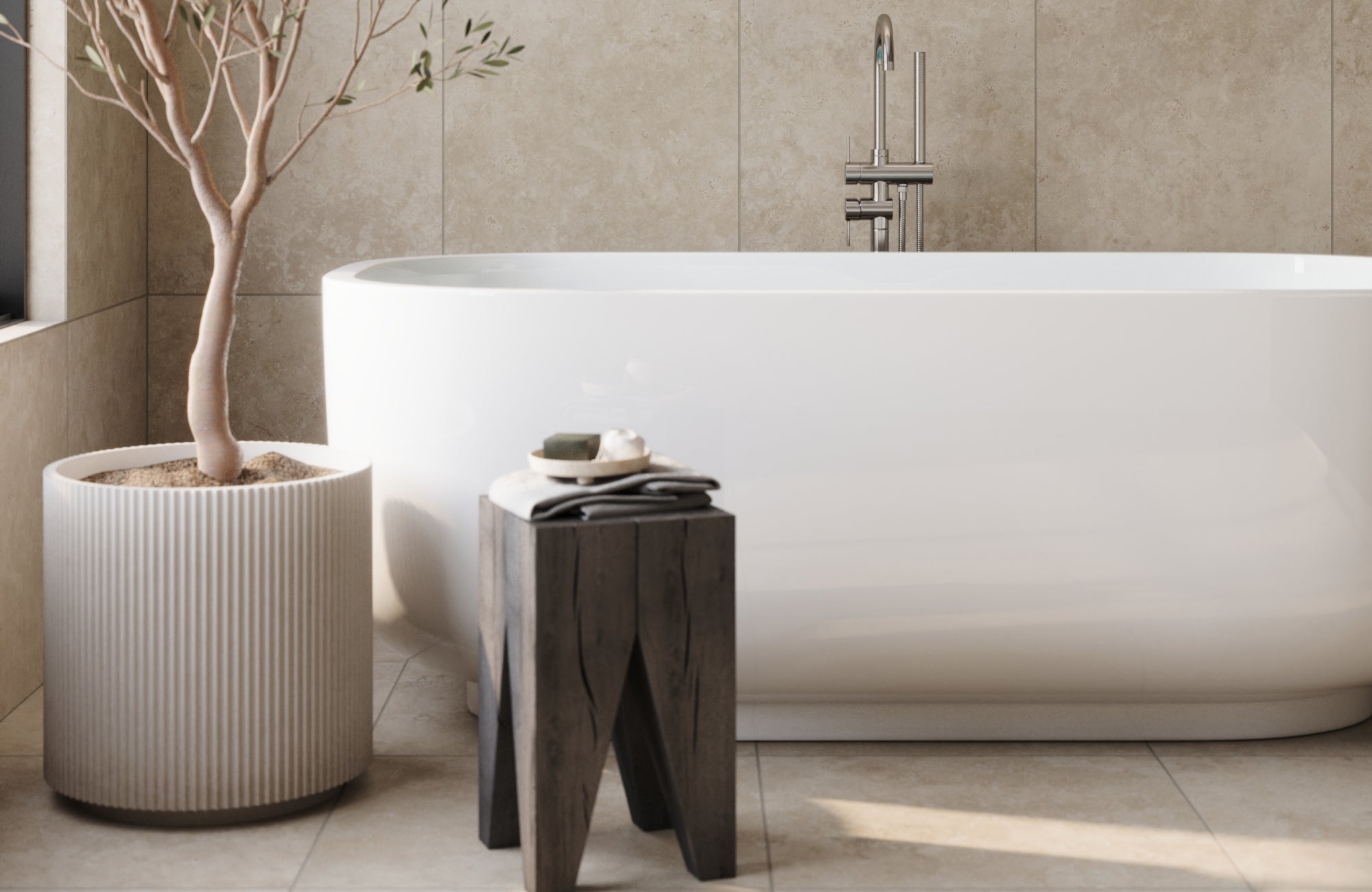 Neutral-tone large-format tiles installed behind and beneath a modern freestanding tub for a serene, spa-like aesthetic.