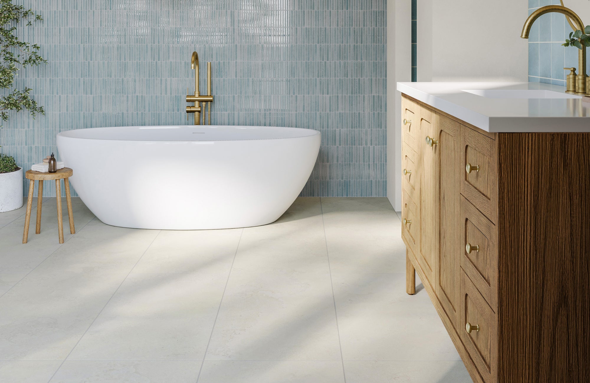 Large-format bathroom tiles with a natural stone appearance shown in a spacious, light-filled modern bath setting.