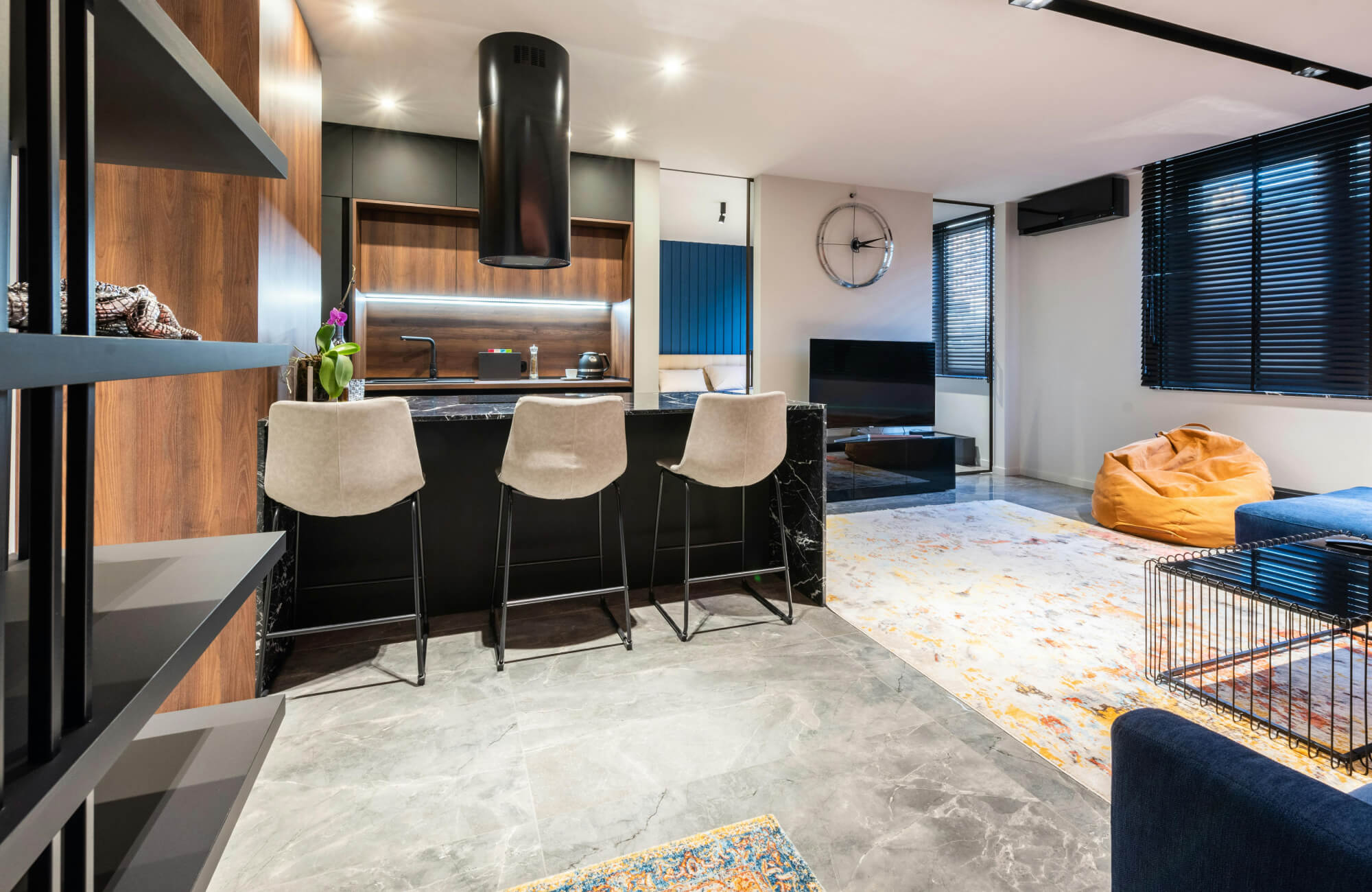 null Contemporary open-plan living area featuring a sleek kitchen island, marble flooring, and cozy seating spaces with modern accents.
