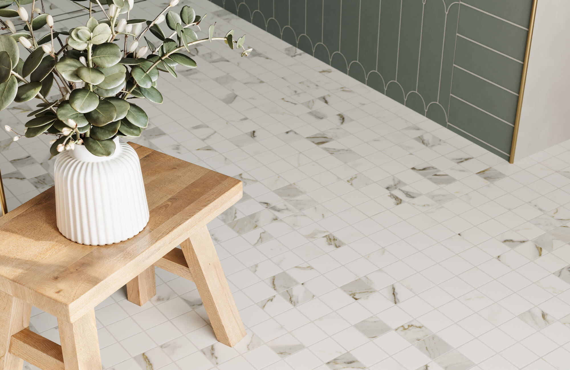 Glossy white mosaic floor tiles with subtle marble veining bring an elegant touch, harmonizing beautifully with a green scalloped accent wall.