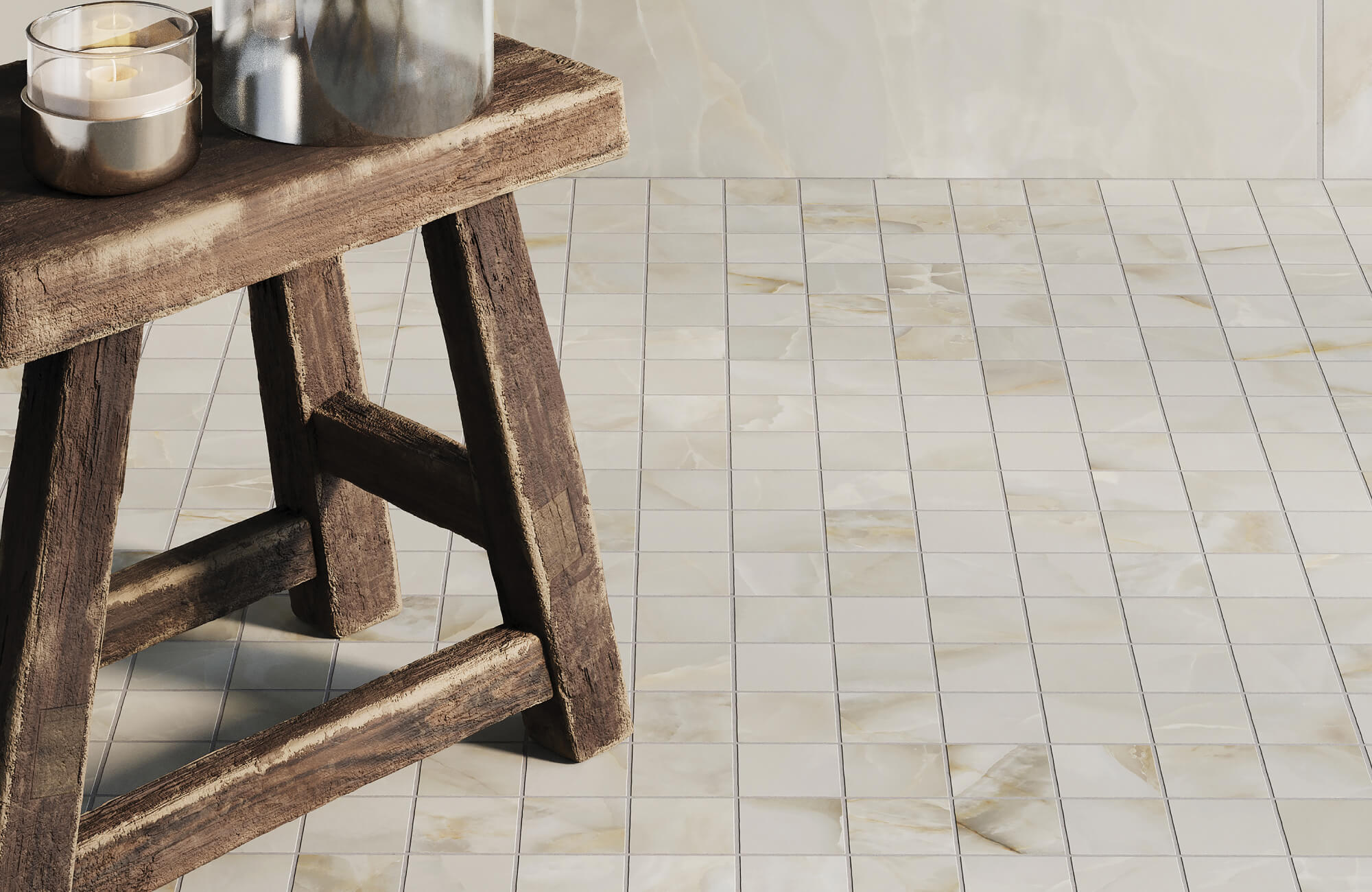 Polished cream mosaic tiles with subtle golden veining exude elegance, paired with a rustic wooden stool adorned with minimalistic candles.
