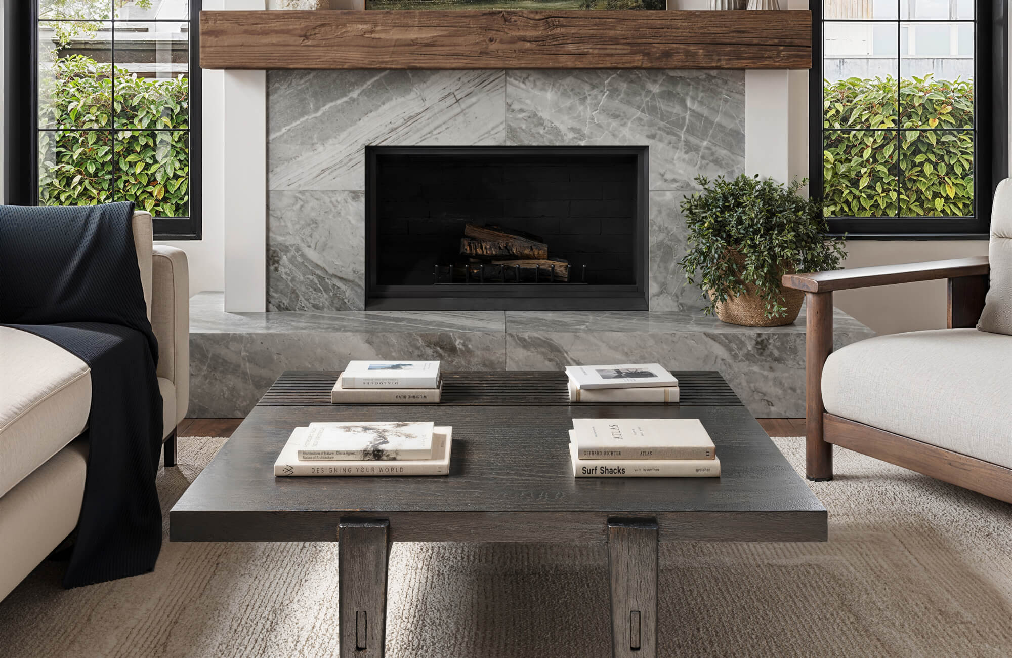 Cozy living room with a textured polypropylene rug grounding a dark wood coffee table, set before a sleek marble fireplace.