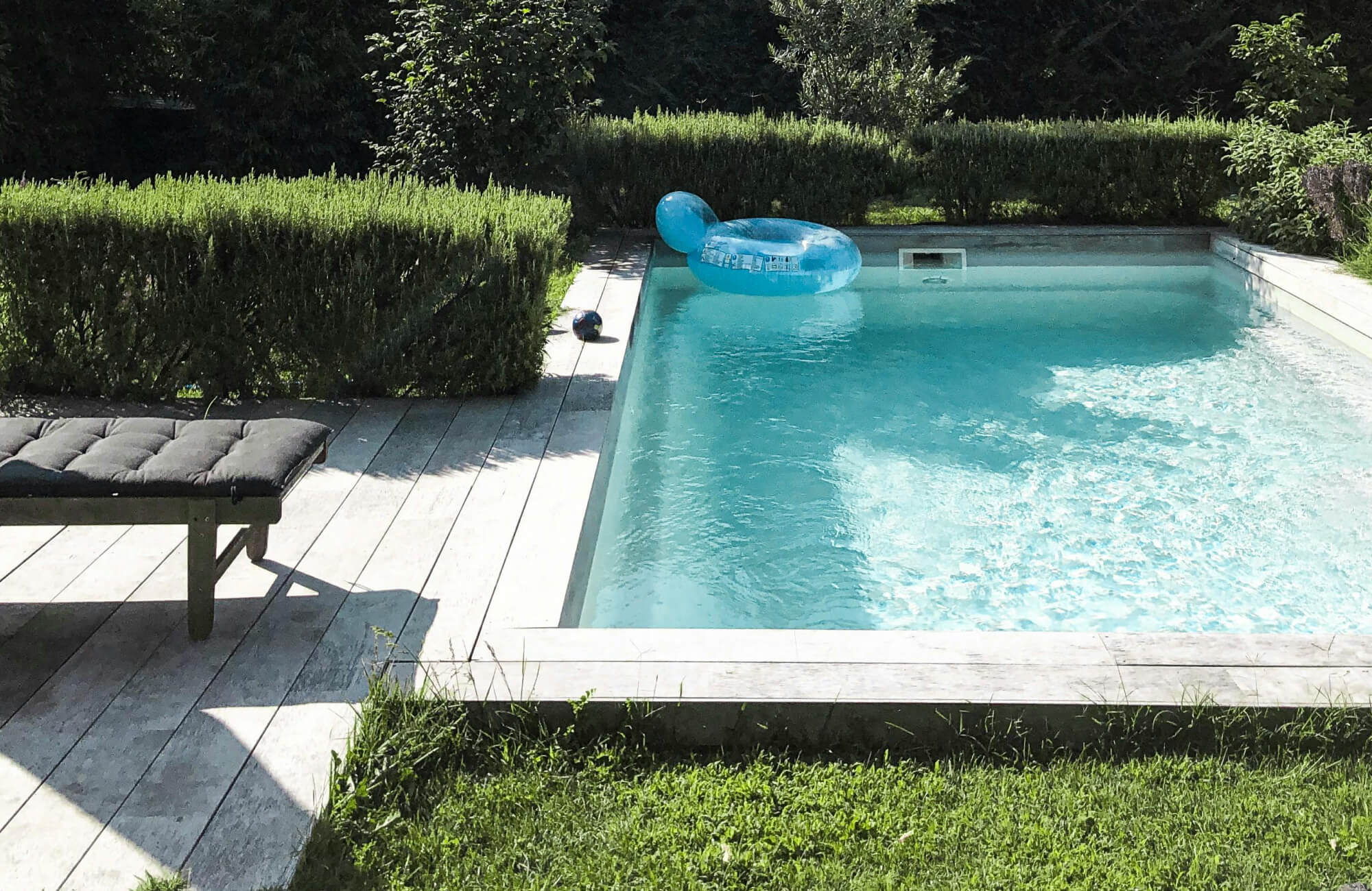 Wood-look porcelain pavers blend rustic charm with poolside durability offering a natural aesthetic and low-maintenance performance