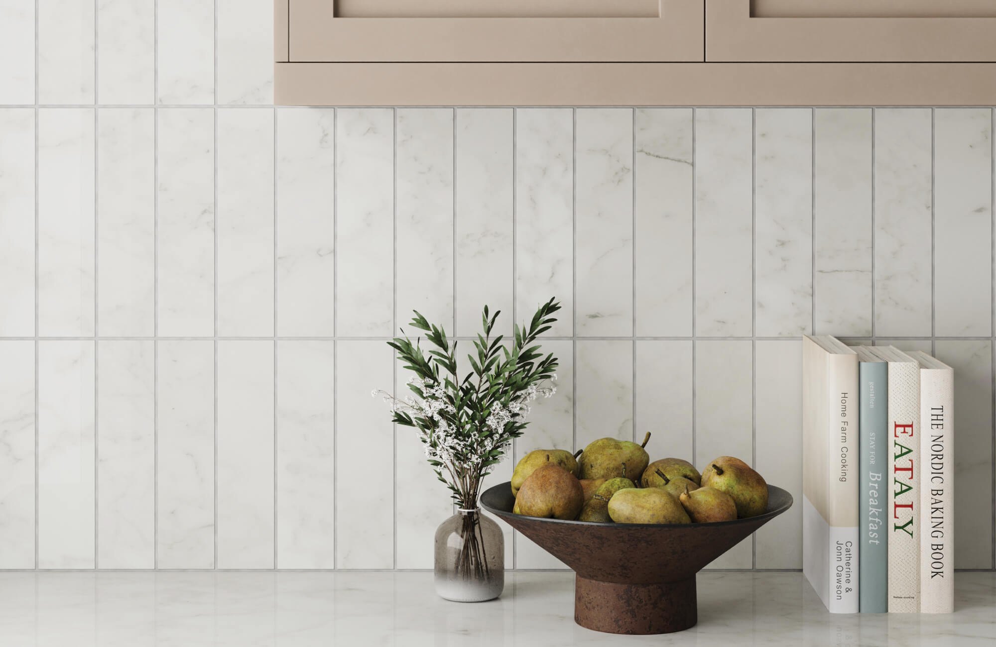 null Vertical white subway backsplash tiles with delicate gray marble veining bring a crisp, tailored look, softened by beige cabinetry, green pears, and natural decorative accents.