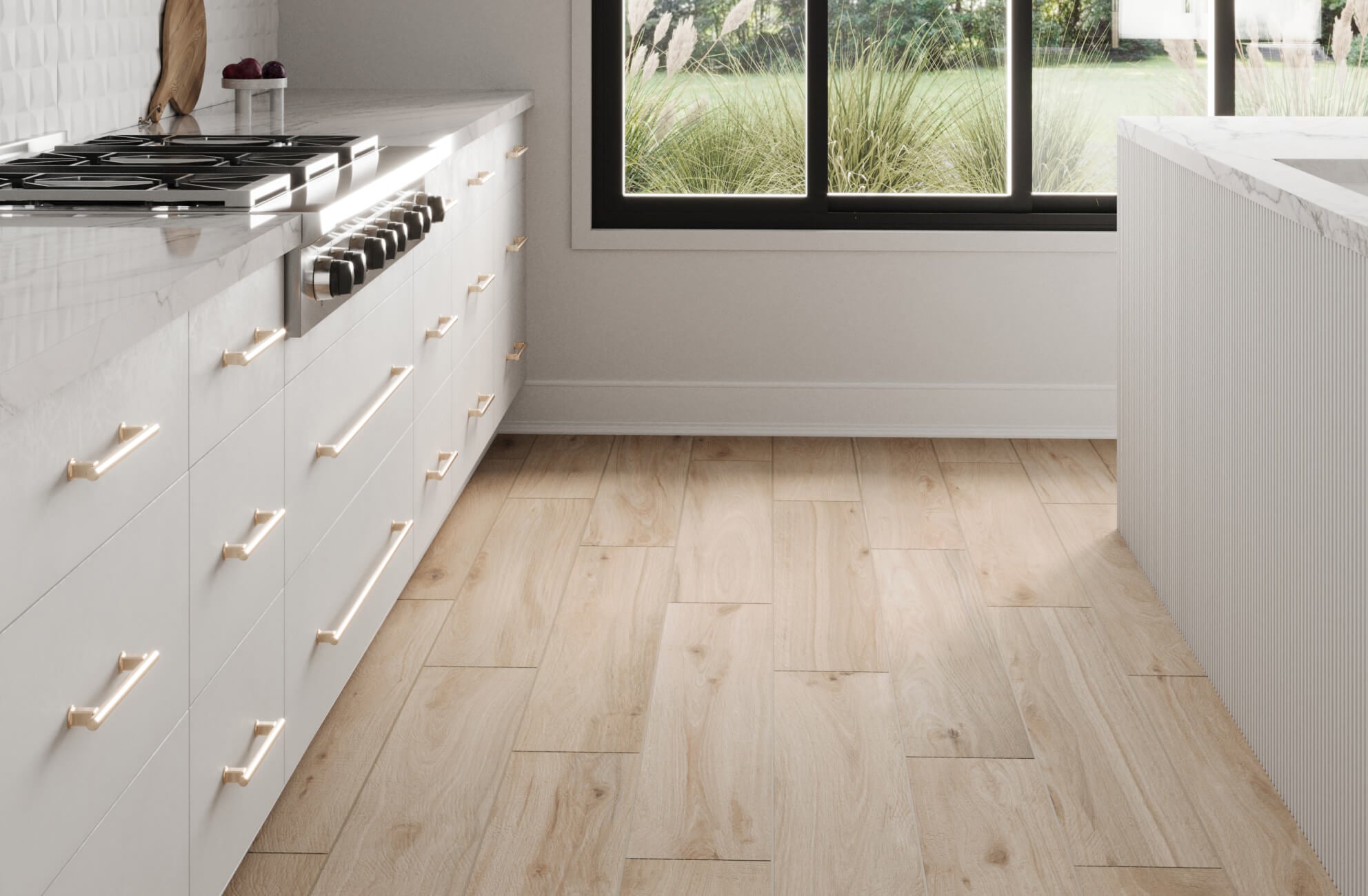 Bright and airy kitchen featuring light oak wood look tile flooring, paired with sleek white cabinetry and gold hardware for a modern touch.