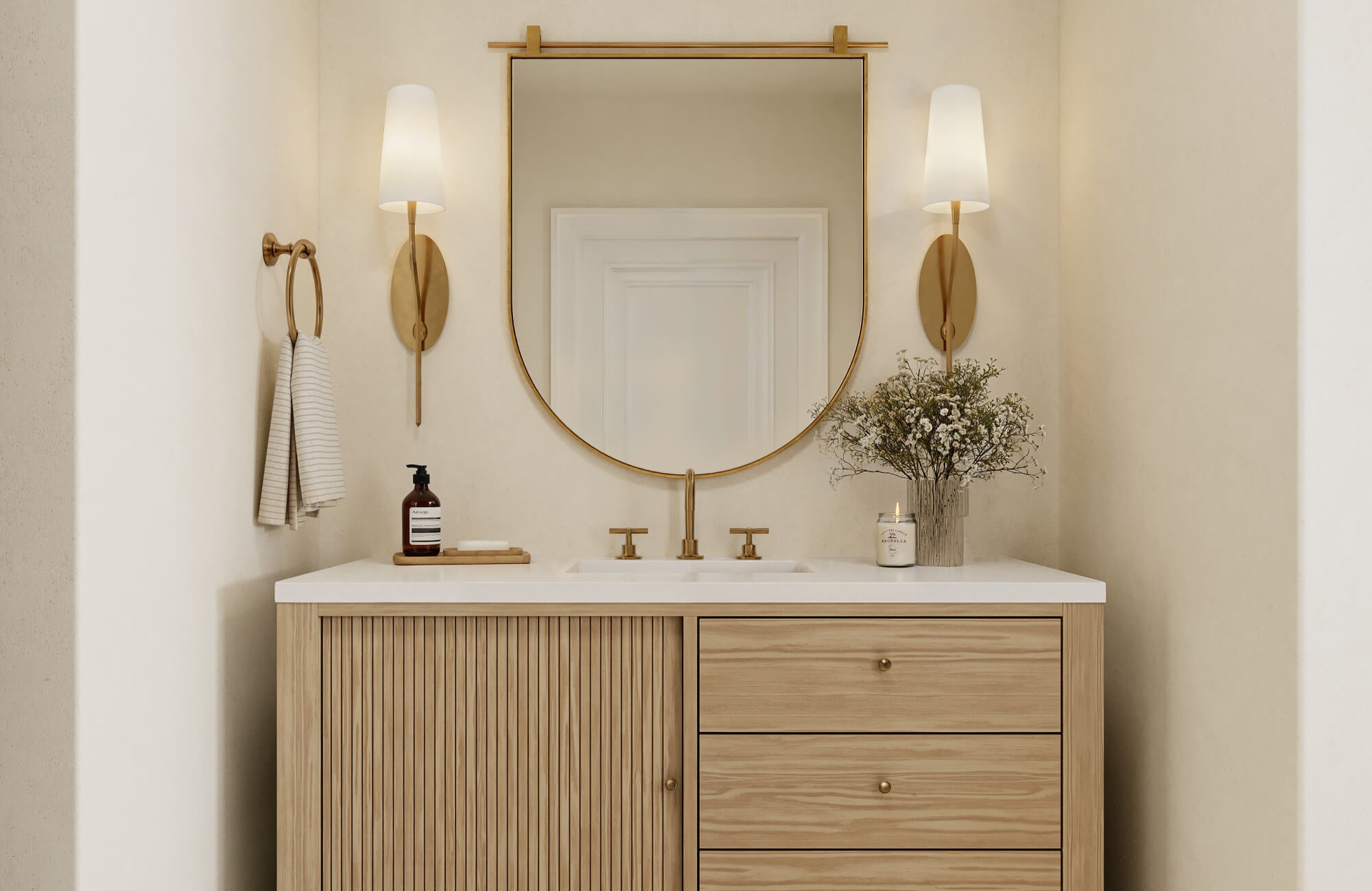 null Light wood vanity with slatted cabinet doors, sleek drawers, a white countertop, and brass fixtures for a warm modern appeal.