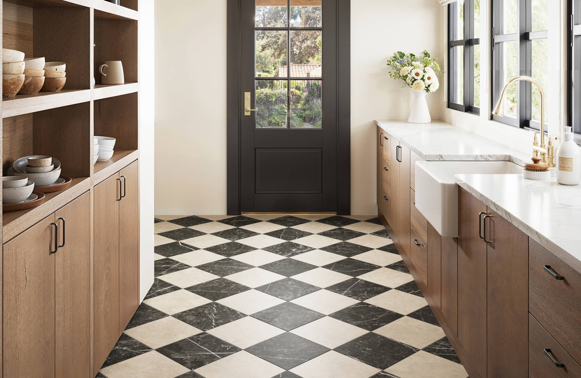 null Black and white marble look checkerboard tiles add a bold, elegant contrast to this warm, modern farmhouse kitchen.