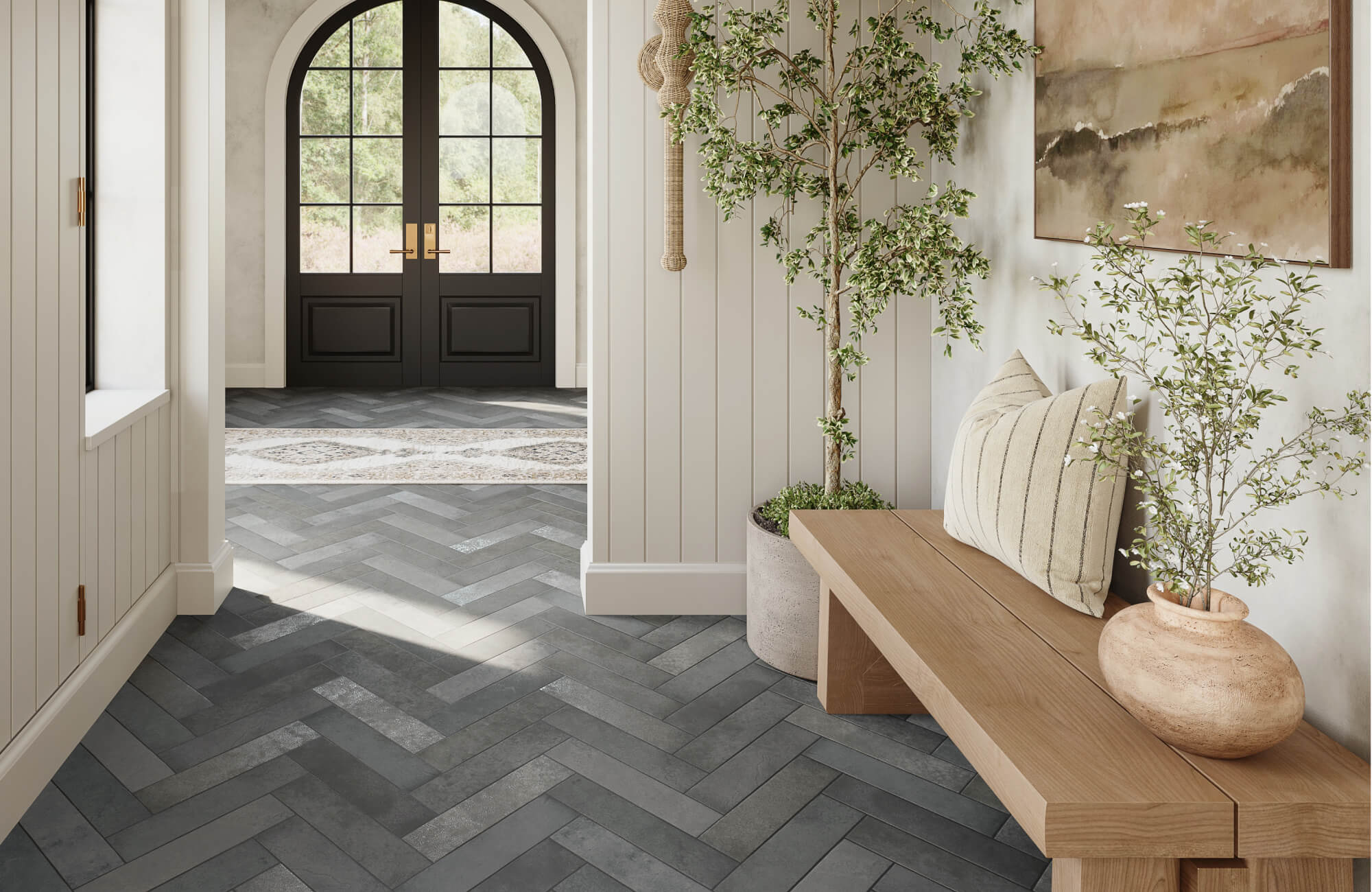 null Bright entryway with dark herringbone subway tile flooring, arched black doors, wood bench, and botanical wall art.