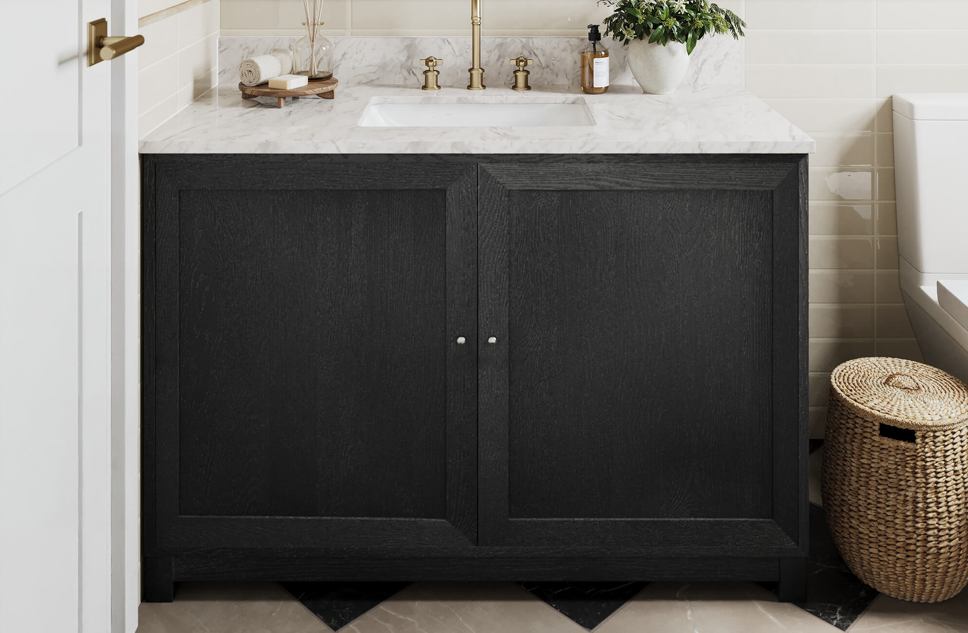 Modern black vanity with marble countertop, brass fixtures, and cream subway tile backsplash.