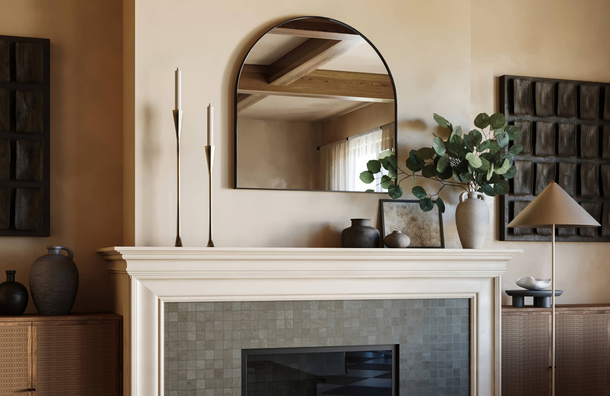 Elegant living room with an arched mirror above a white mantel, surrounded by modern decor, candles, and greenery in neutral earth tones.