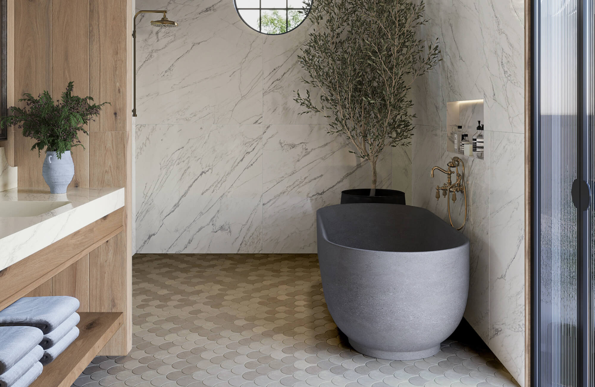 Spa-inspired bathroom featuring marble-look wall tiles, neutral scallop mosaic floor tiles, a freestanding stone tub, and brass fixtures.