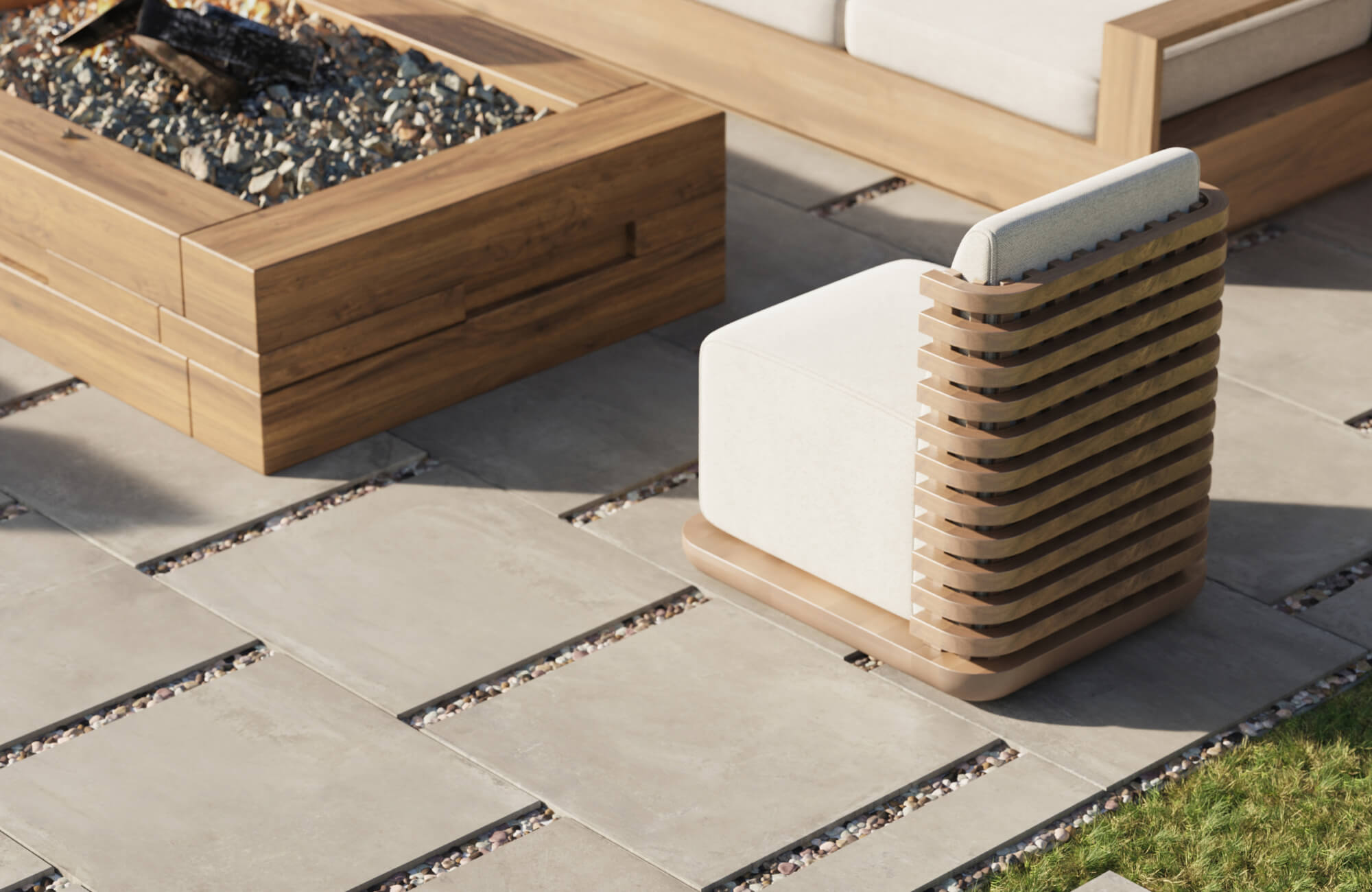 Modern outdoor patio with light beige porcelain pavers, gravel-filled joints, wooden fire pit, and contemporary cushioned seating.
