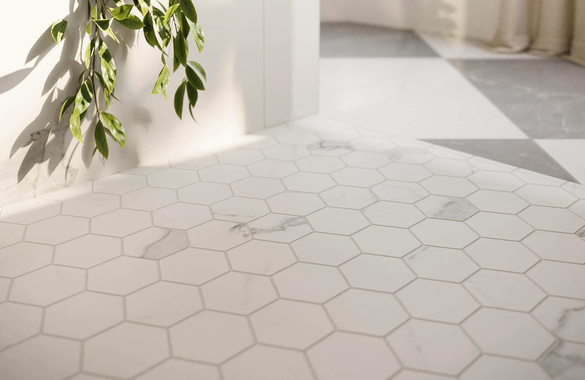Hexagonal tile flooring in a light neutral palette, highlighted by natural light and nearby greenery.