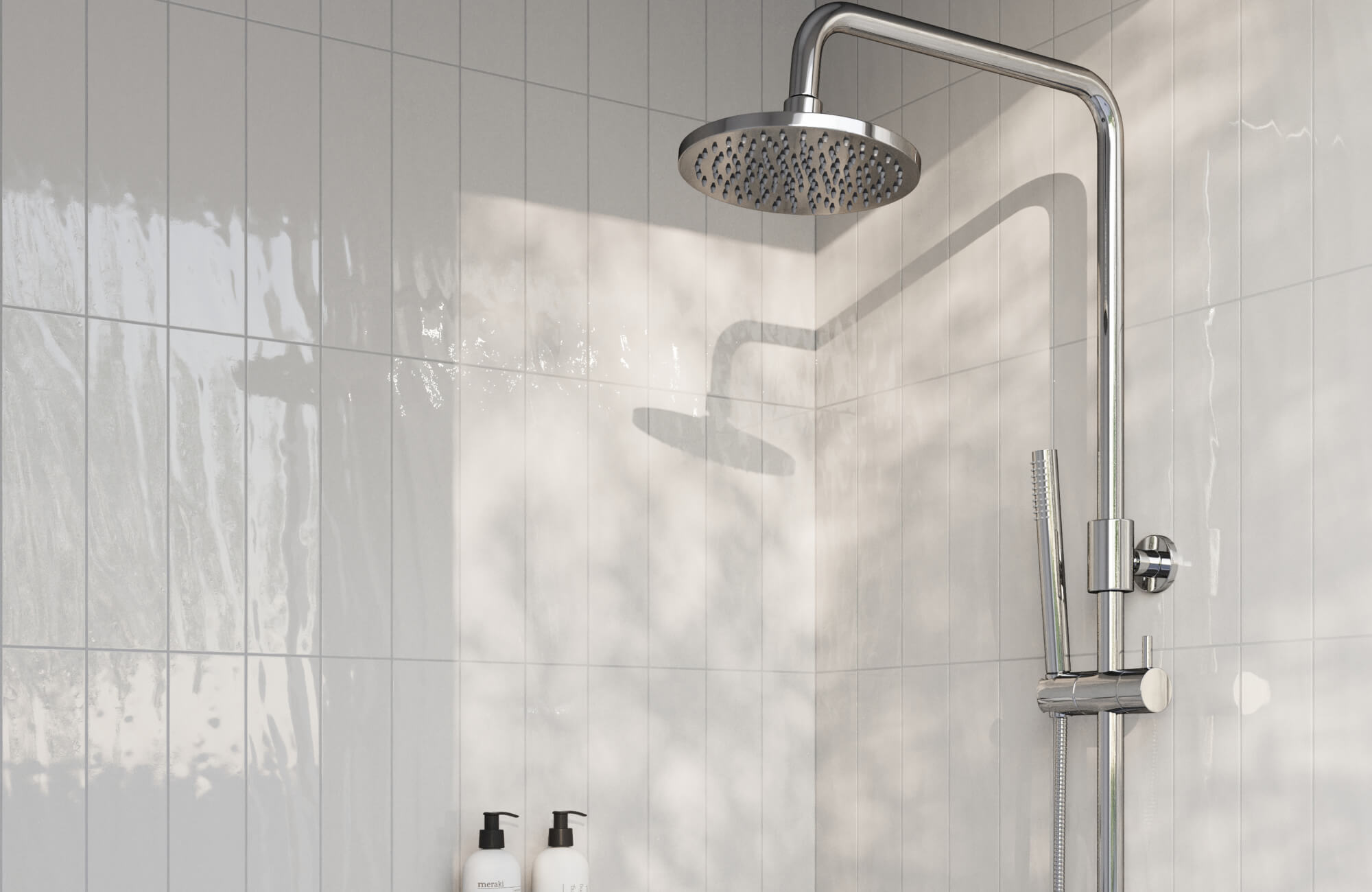 Modern shower with sleek chrome fixtures against glossy white subway tiles, reflecting natural light for a bright, clean look.