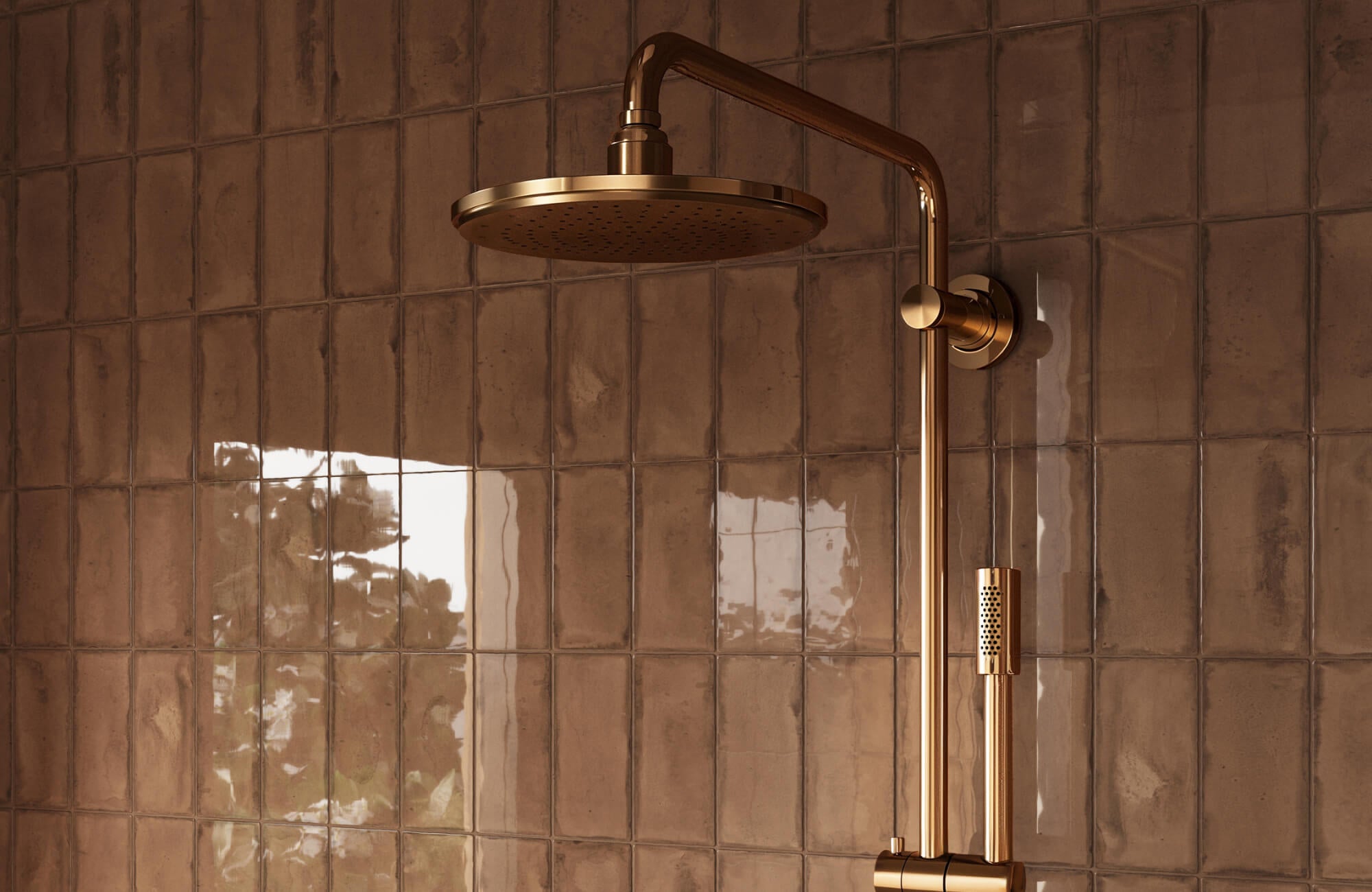 Glossy brown subway tiles paired with a brass rainfall showerhead, creating a warm and luxurious shower ambiance.