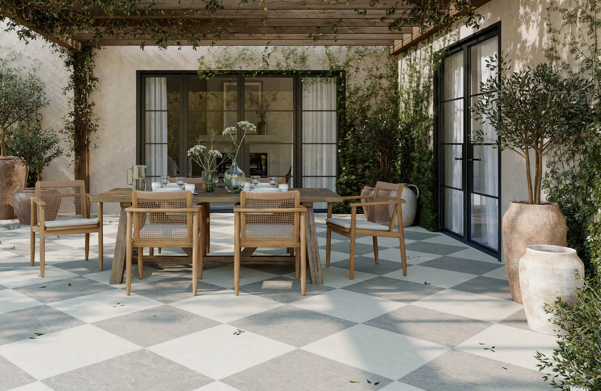 Elegant outdoor patio with checkerboard stone tiles in soft grey and cream, creating a timeless alfresco dining space.