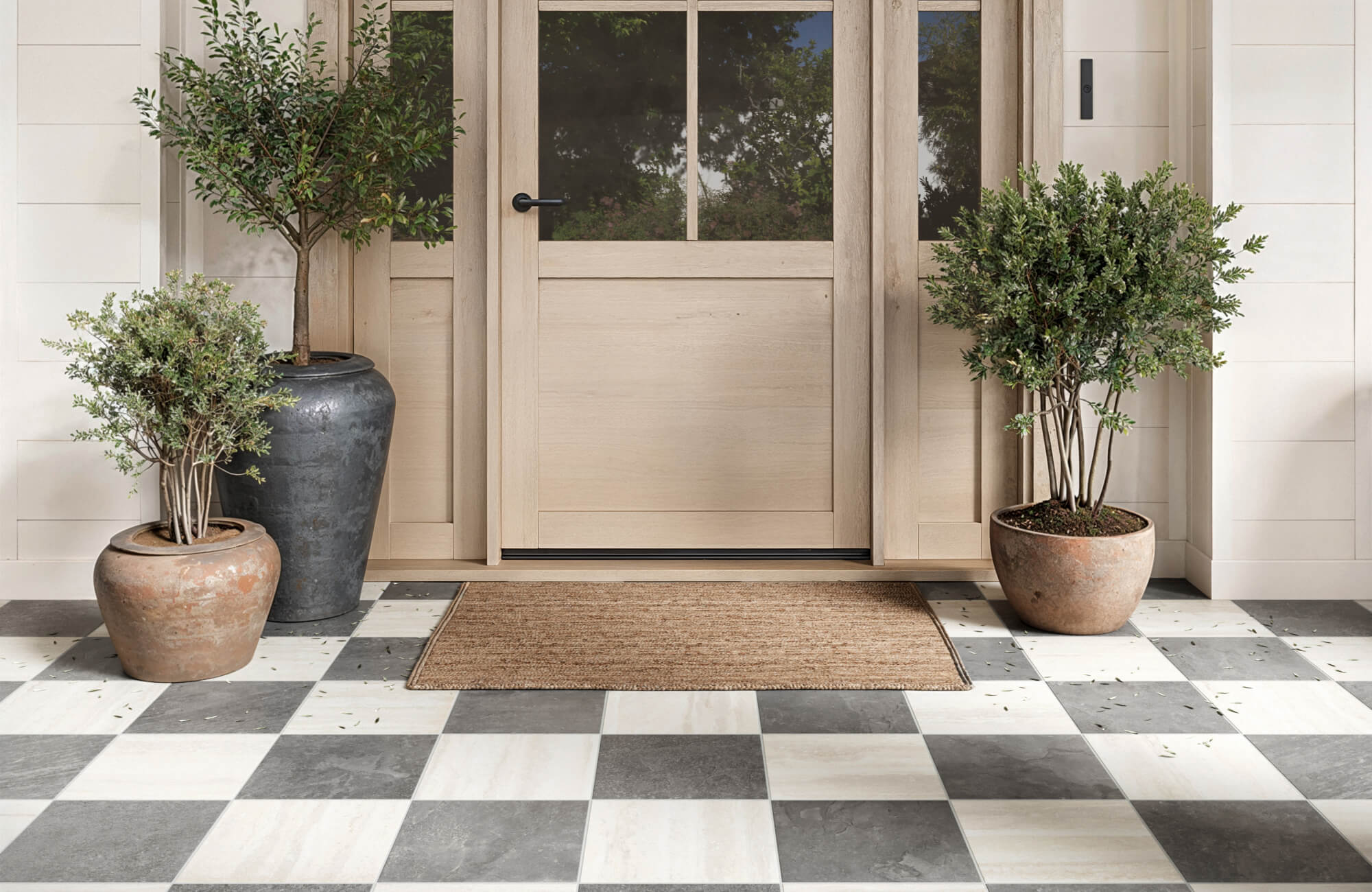 null Welcoming entryway with grey and ivory checkerboard tiles, framed by rustic planters and a natural wood door.
