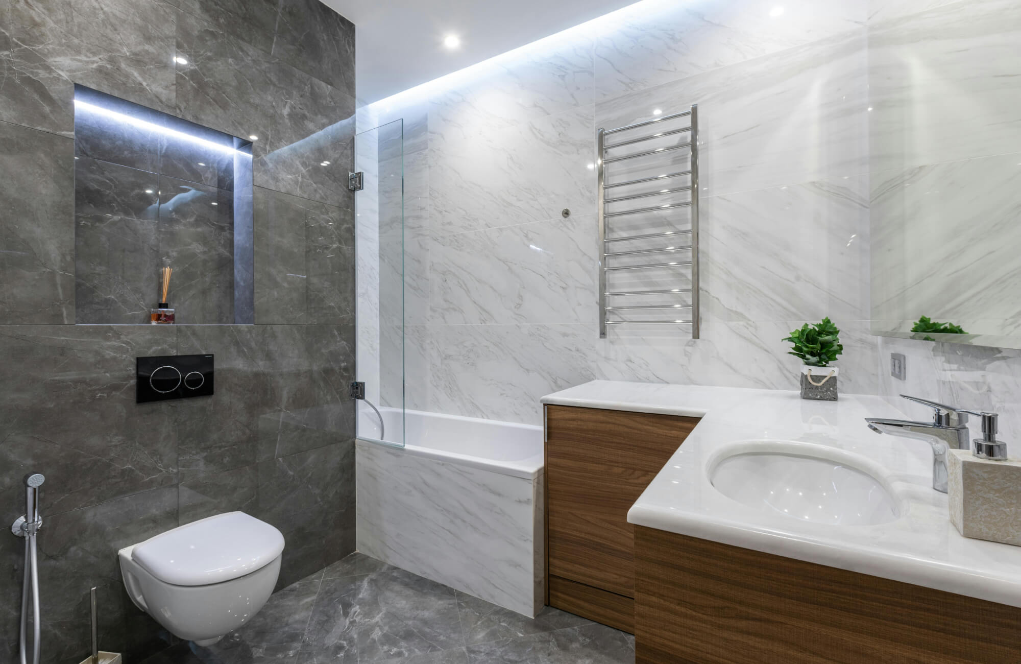 A contemporary bathroom with peel-and-stick gray marble walls and wood accents showing how design and function work together.