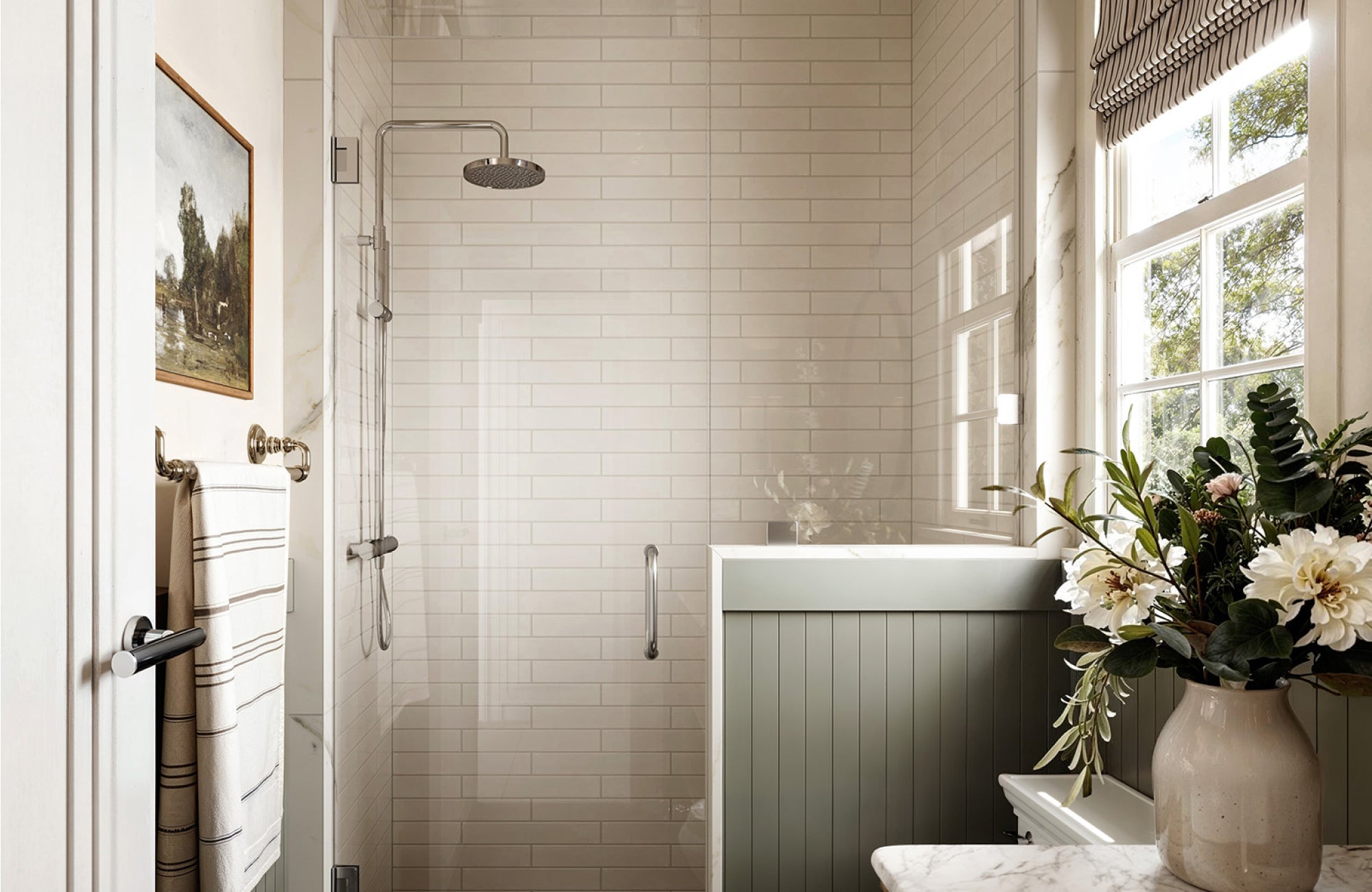 White subway-tiled shower with chrome fixtures and soft natural light, blending classic design with modern elegance.