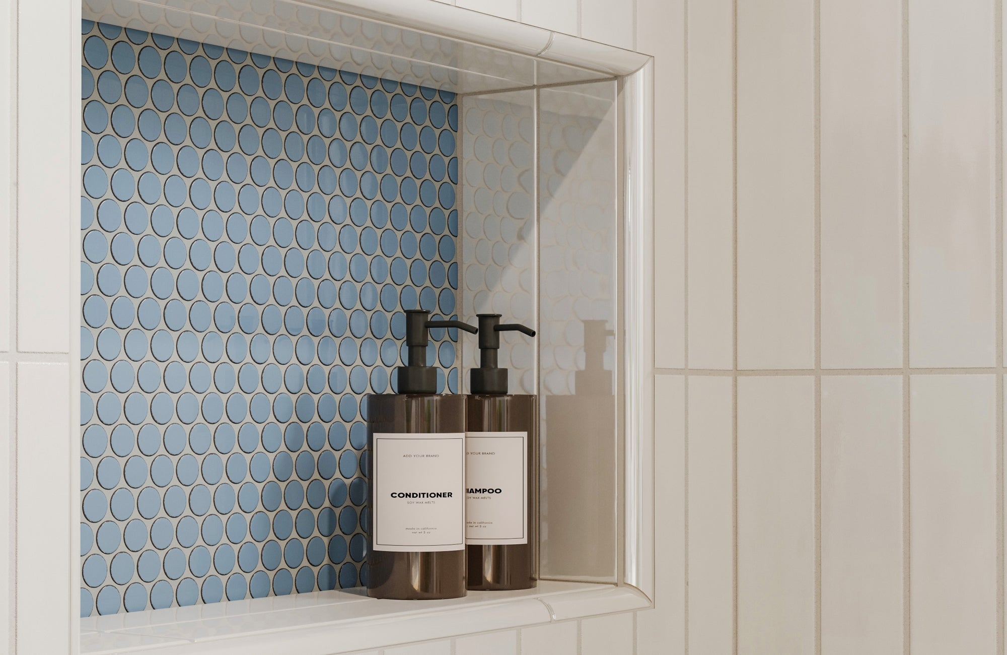 Blue penny round mosaic accent in a recessed shower niche framed by white vertical tiles for a playful yet refined detail.